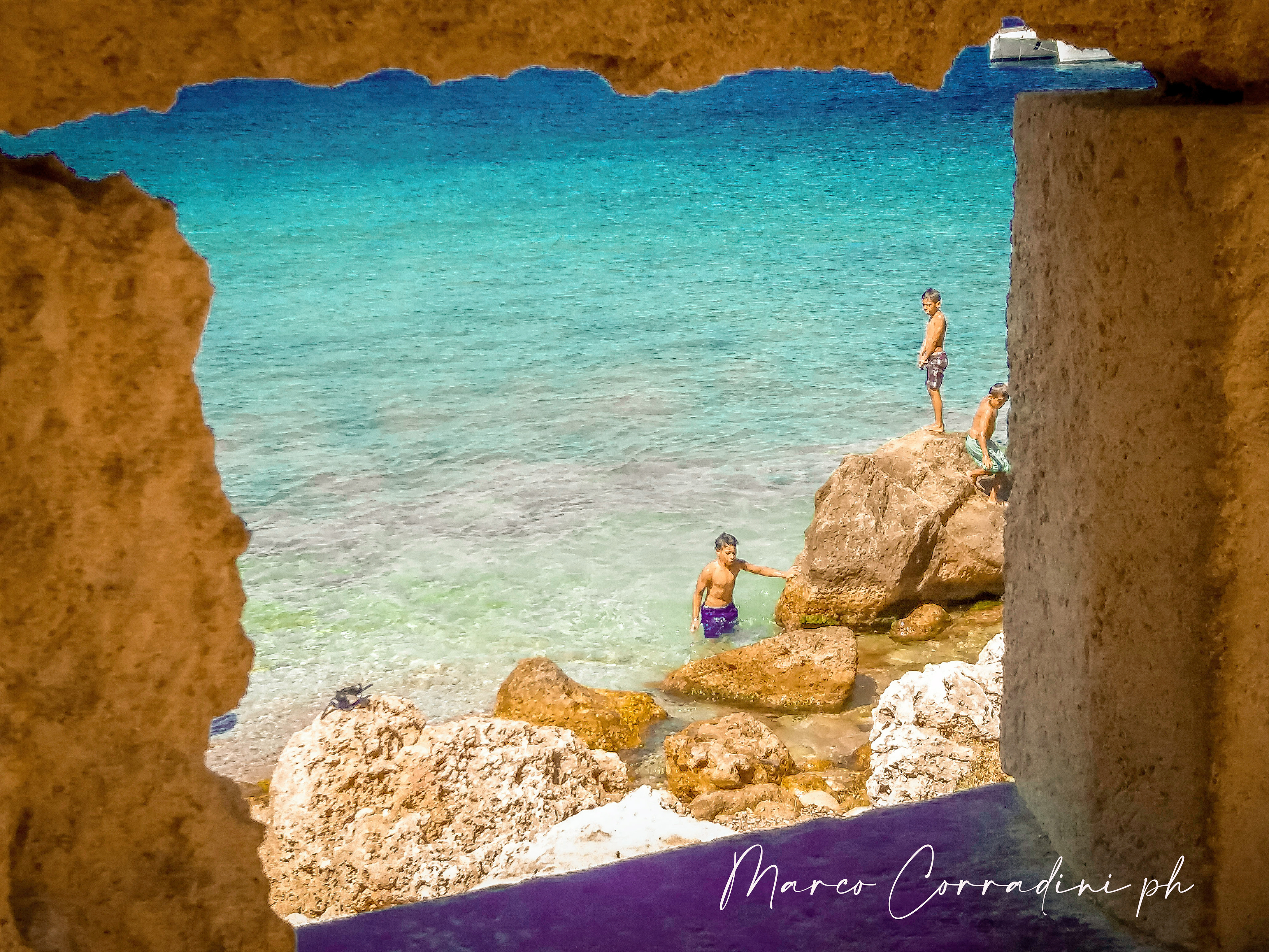 children jump into the sea from the rocks