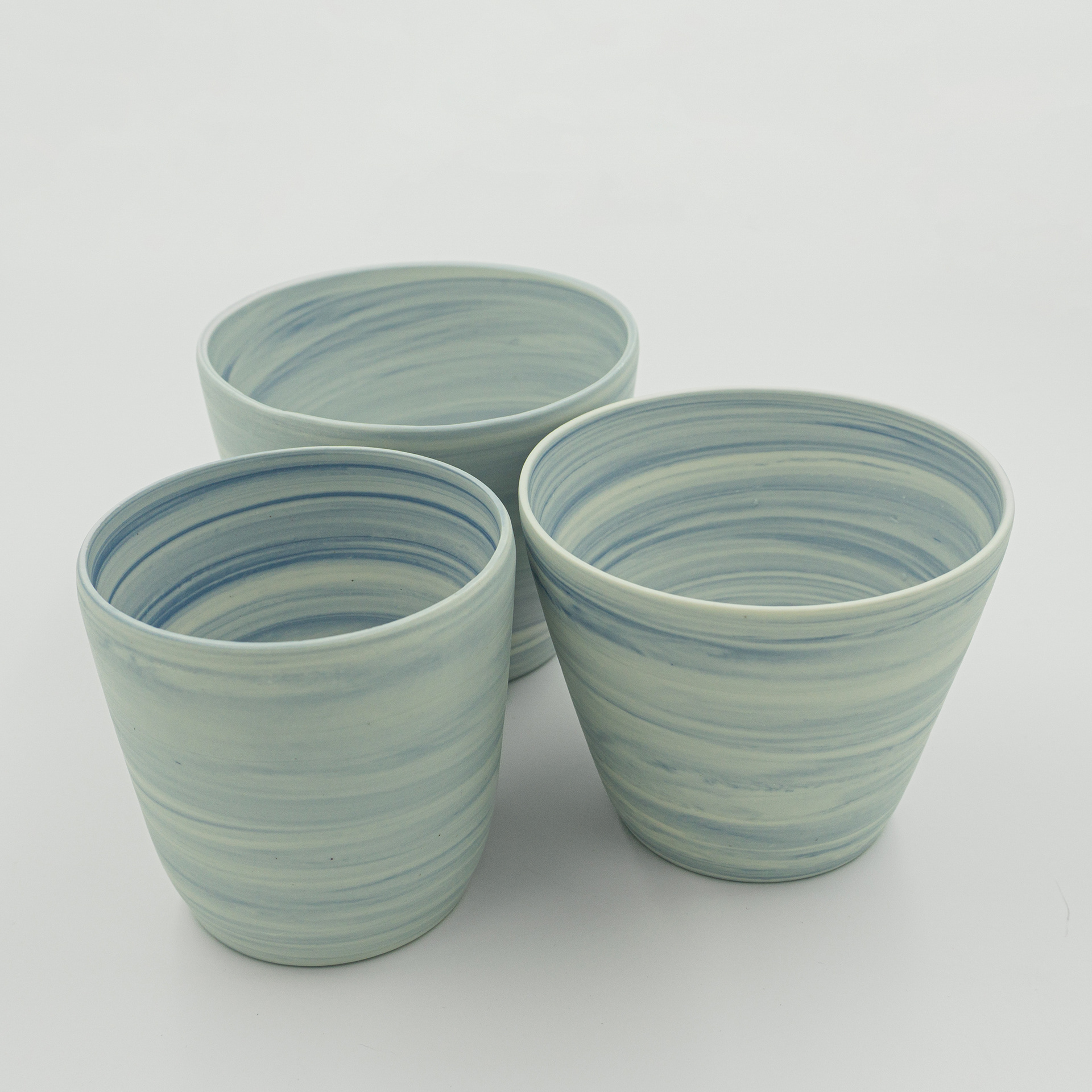 Three beakers in white & blue porcelain