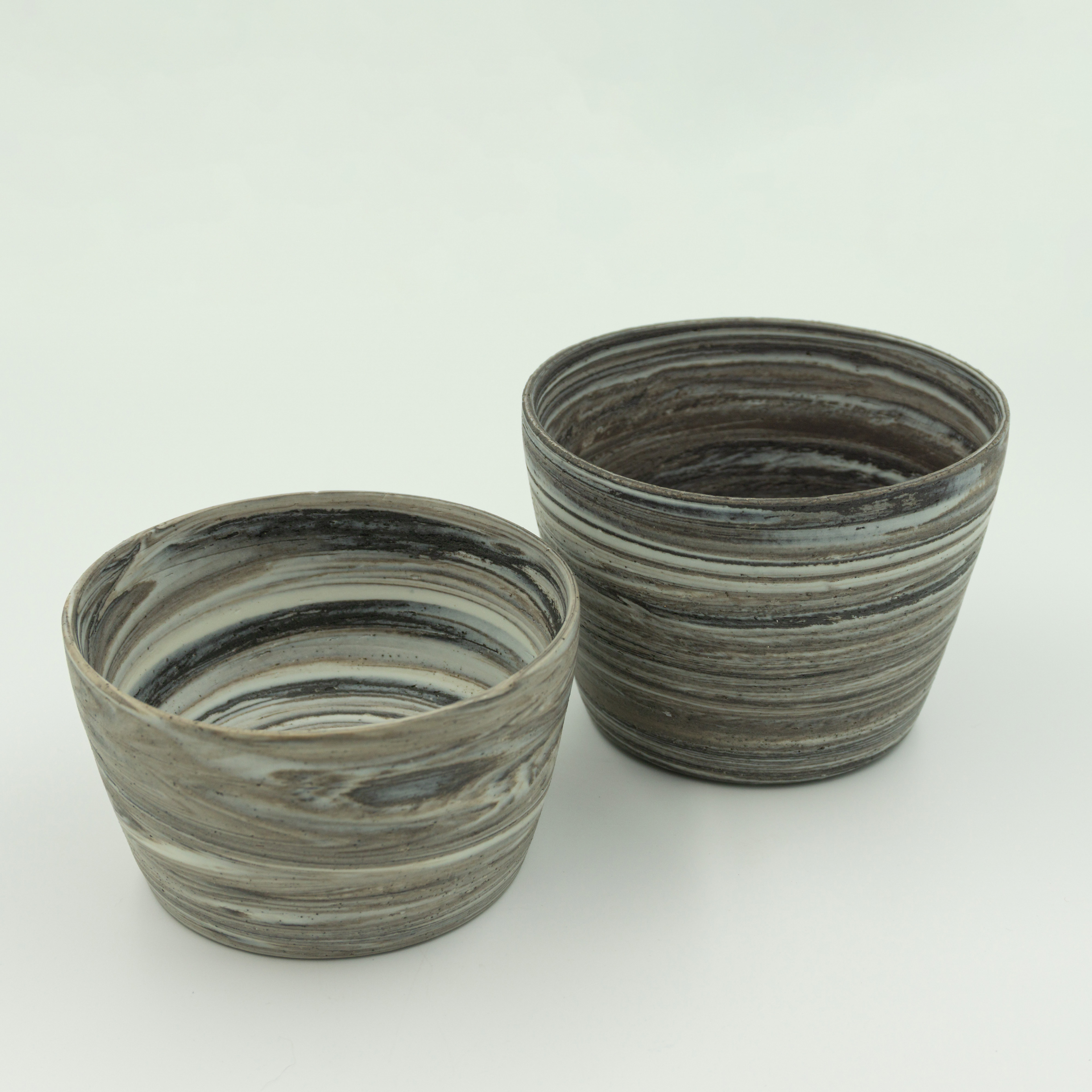 Two beakers in white porcelain & black clay