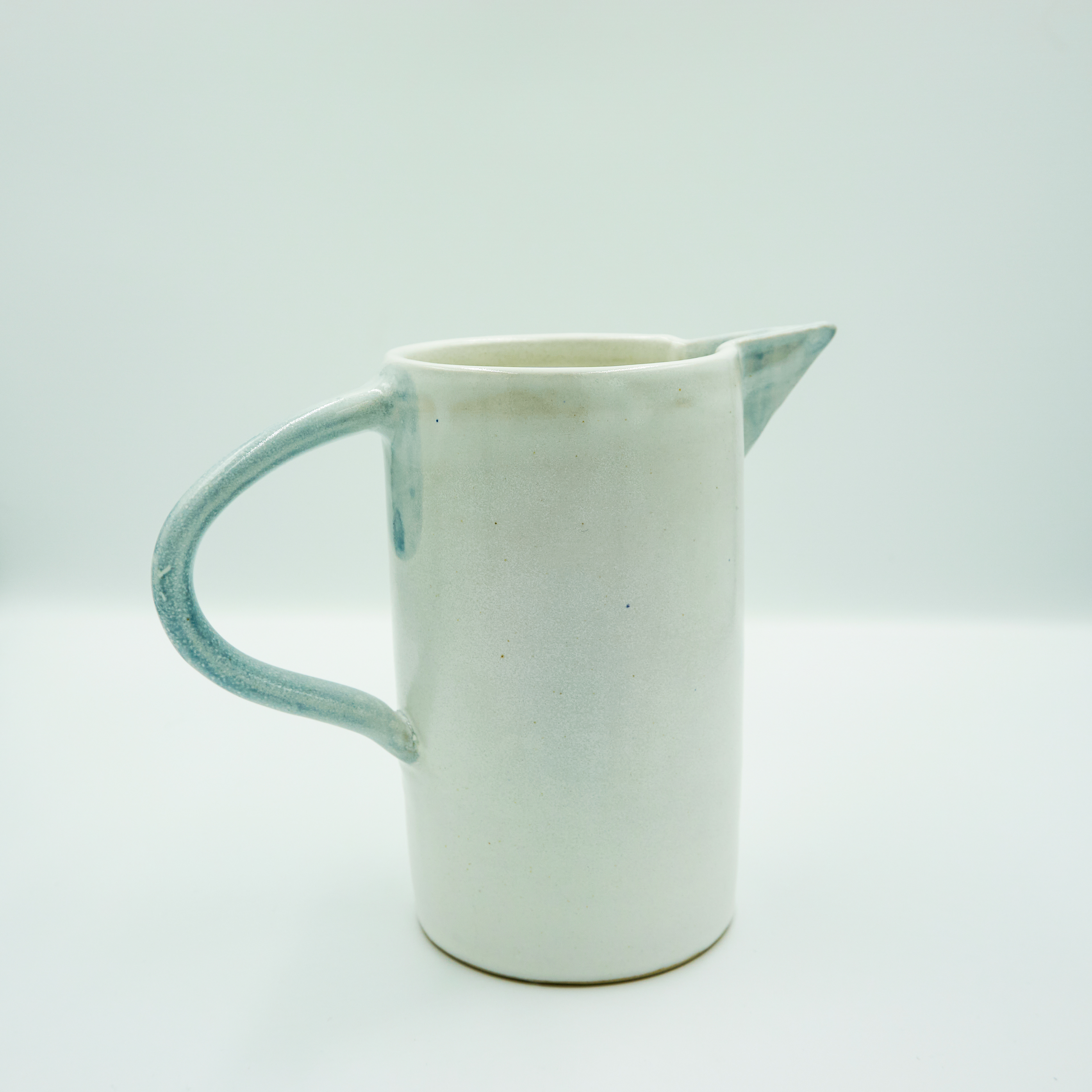 Jug with angular spout in white and blue glazes