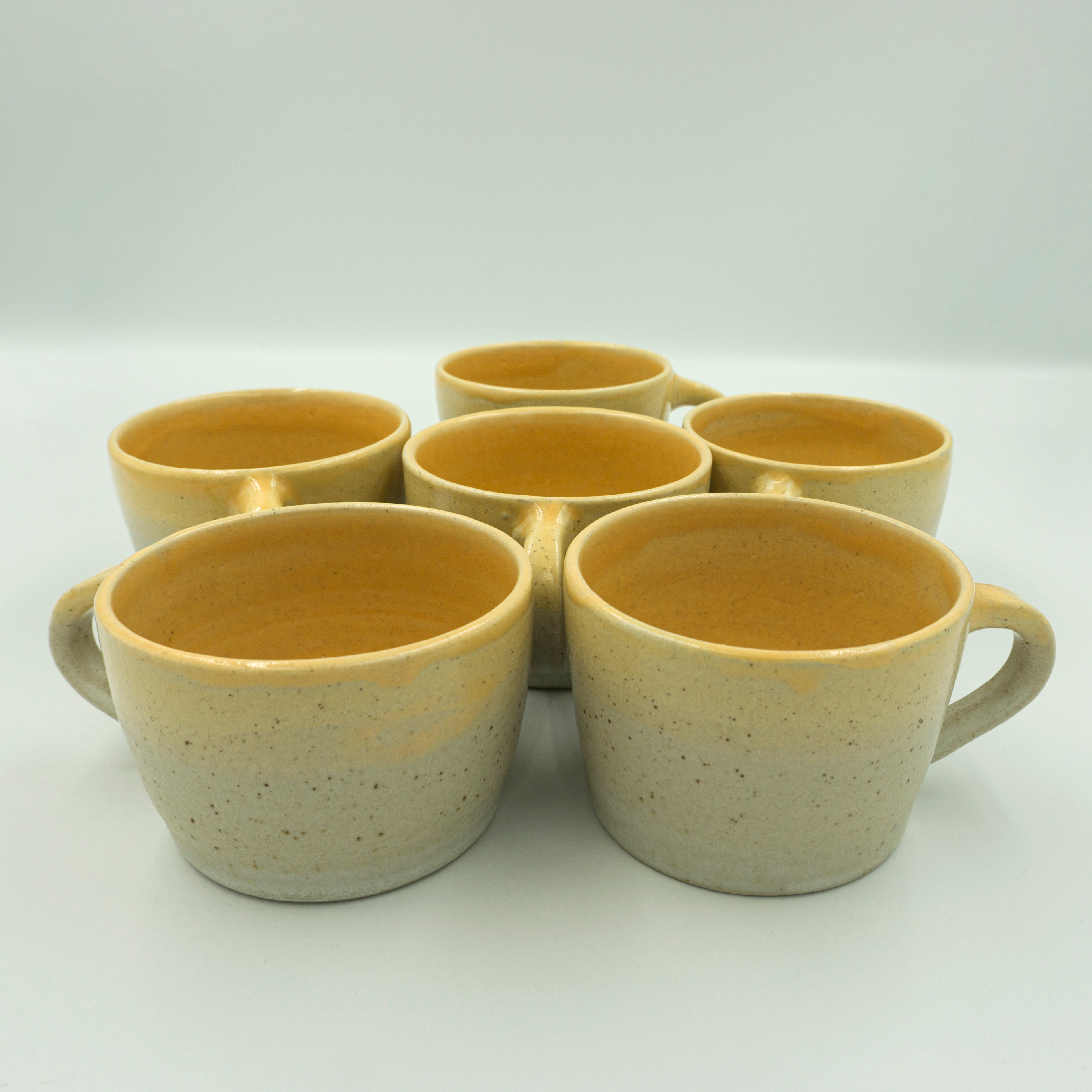 Six cups in shiny yellow and matt Dolomite glazes