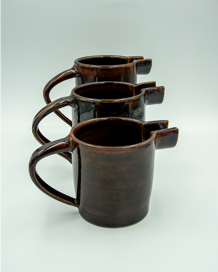 Three jugs, different sizes, in tenmoku glaze
