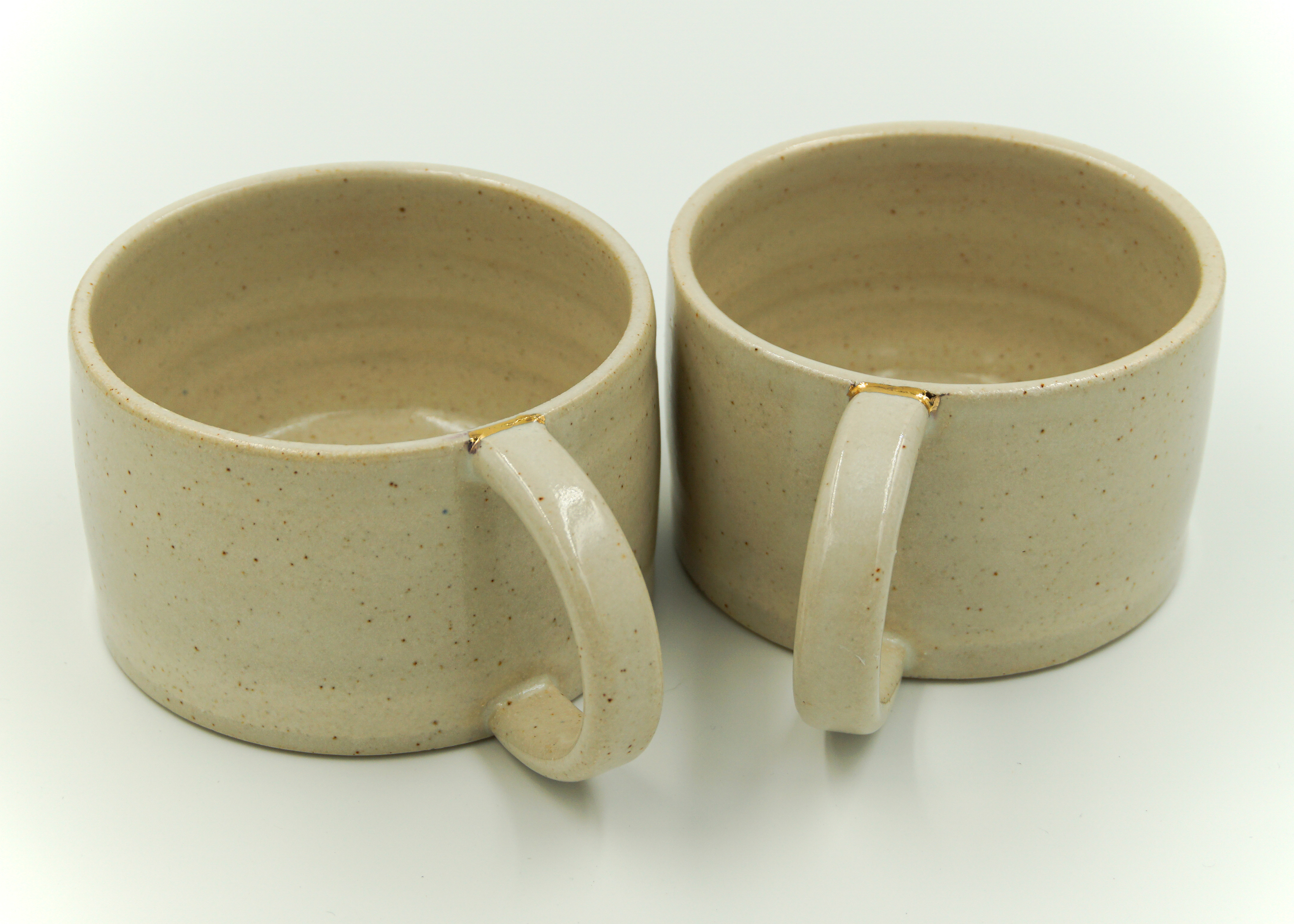 Cups/mugs in cream white glaze with a touch of gold lustre