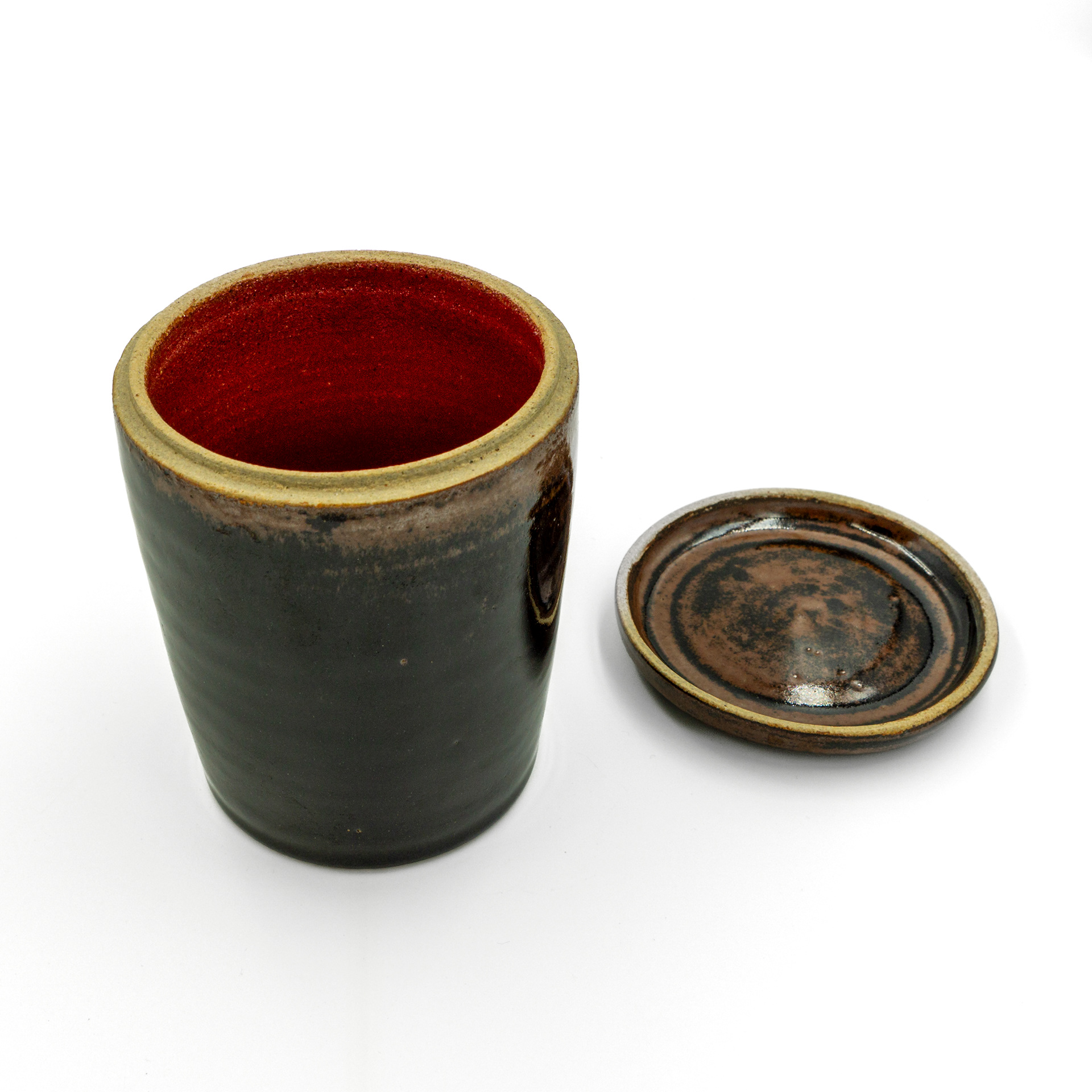 Lidded pot in dark clay finished with tenmoku and 'Intense red' glazes