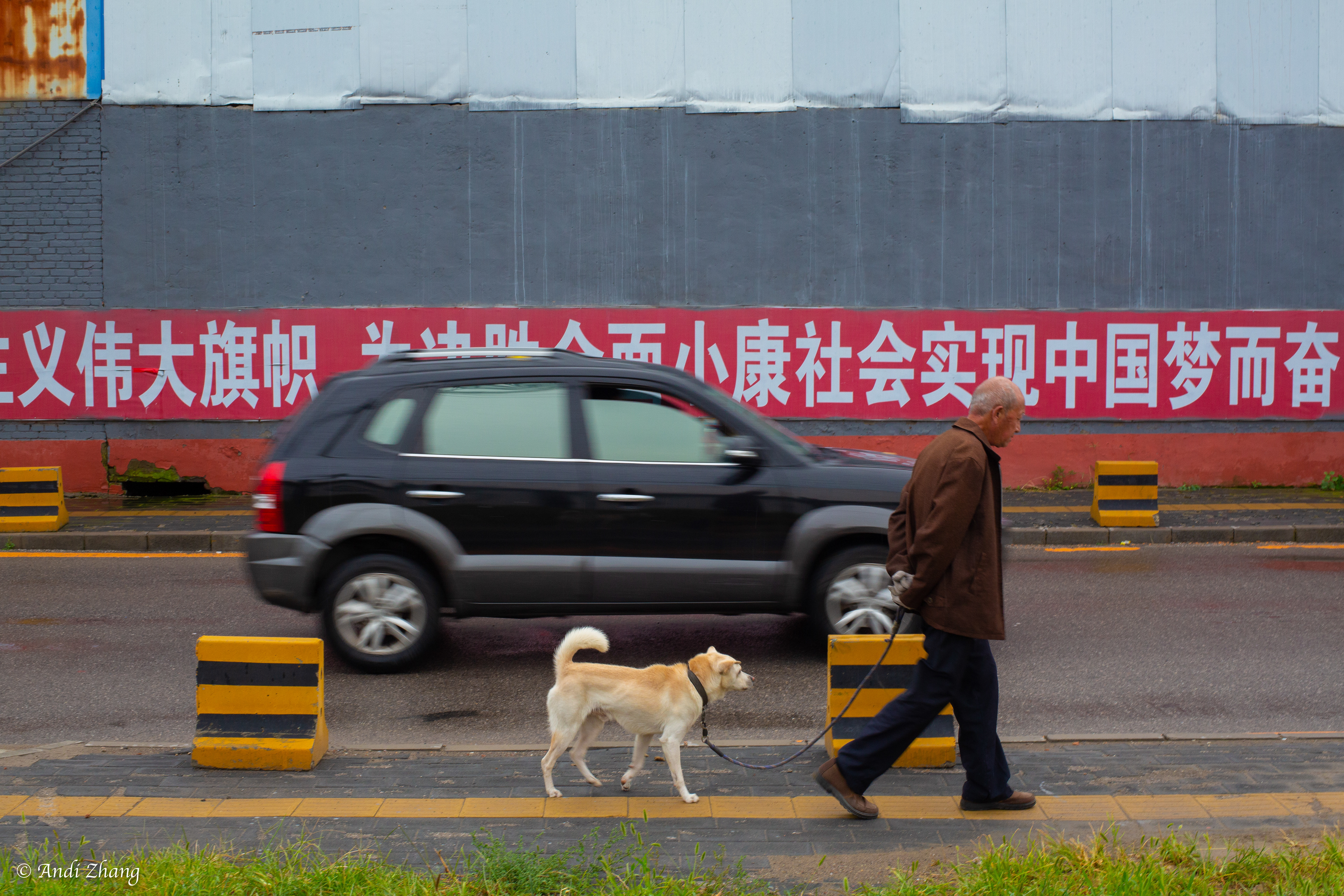 A man walking pass a banner written “hold high the great banner of socialism with Chinese characteristics, secure a decisive victory in building a moderately prosperous society in all respects, work to realize the Chinese Dream of national rejuvenation”. September 14, 2020.