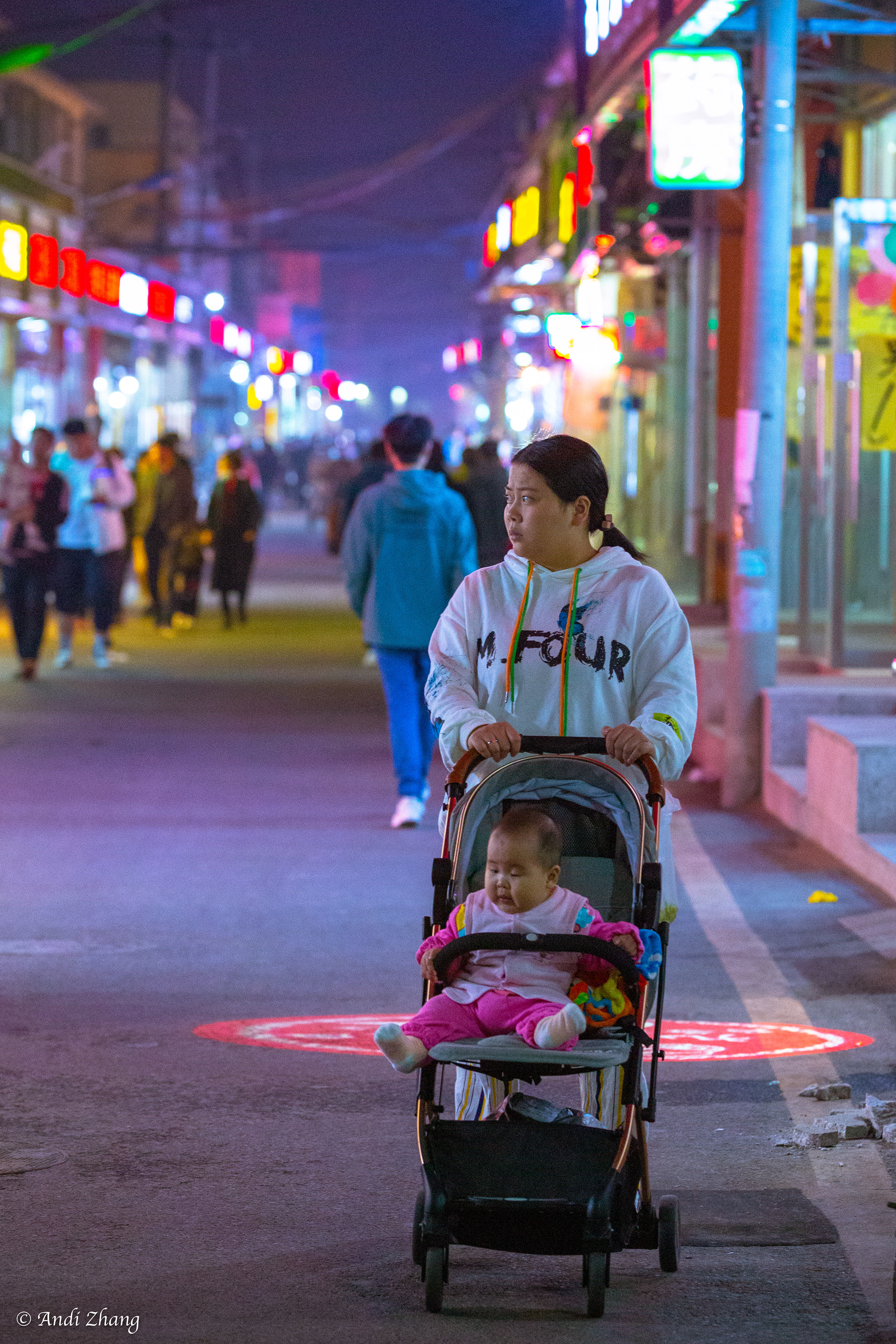 Into the night. A mother pushing the baby stroller. October 10, 2020.