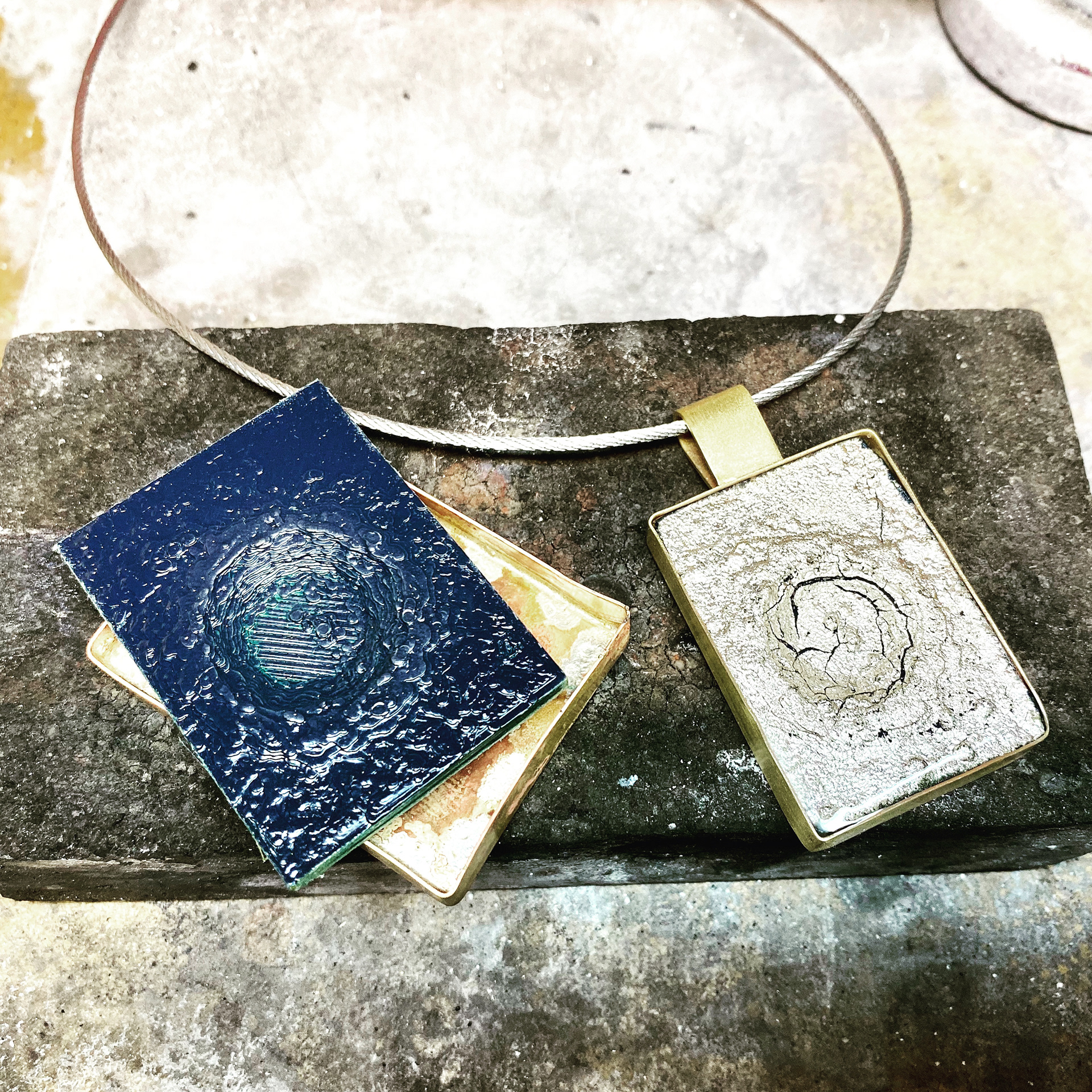 3D printed lunar surface and silver leaf/brass/steel pendant. This 3D print features the Copernicus crater.