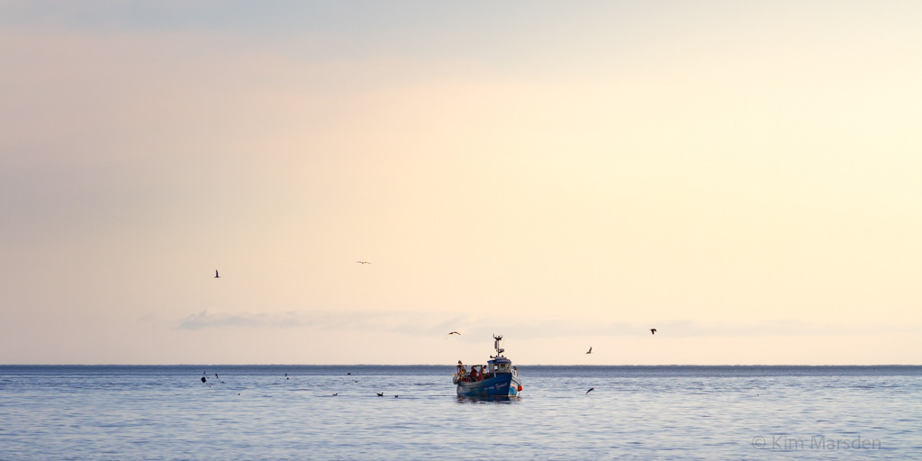Fishing boat in the very early dawn light off Yorkshire Coast