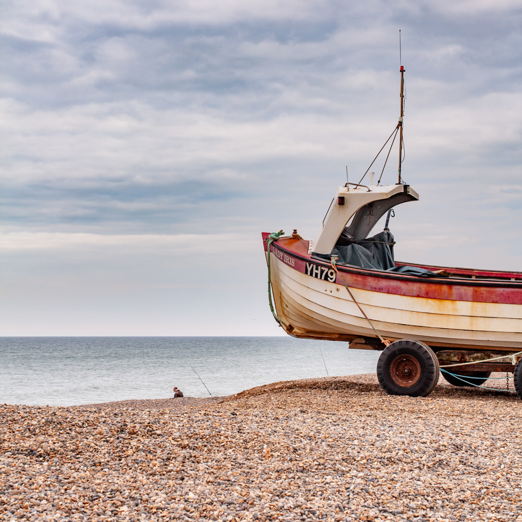 A Lone Norfolk fisherman overlooked by the fishing boat