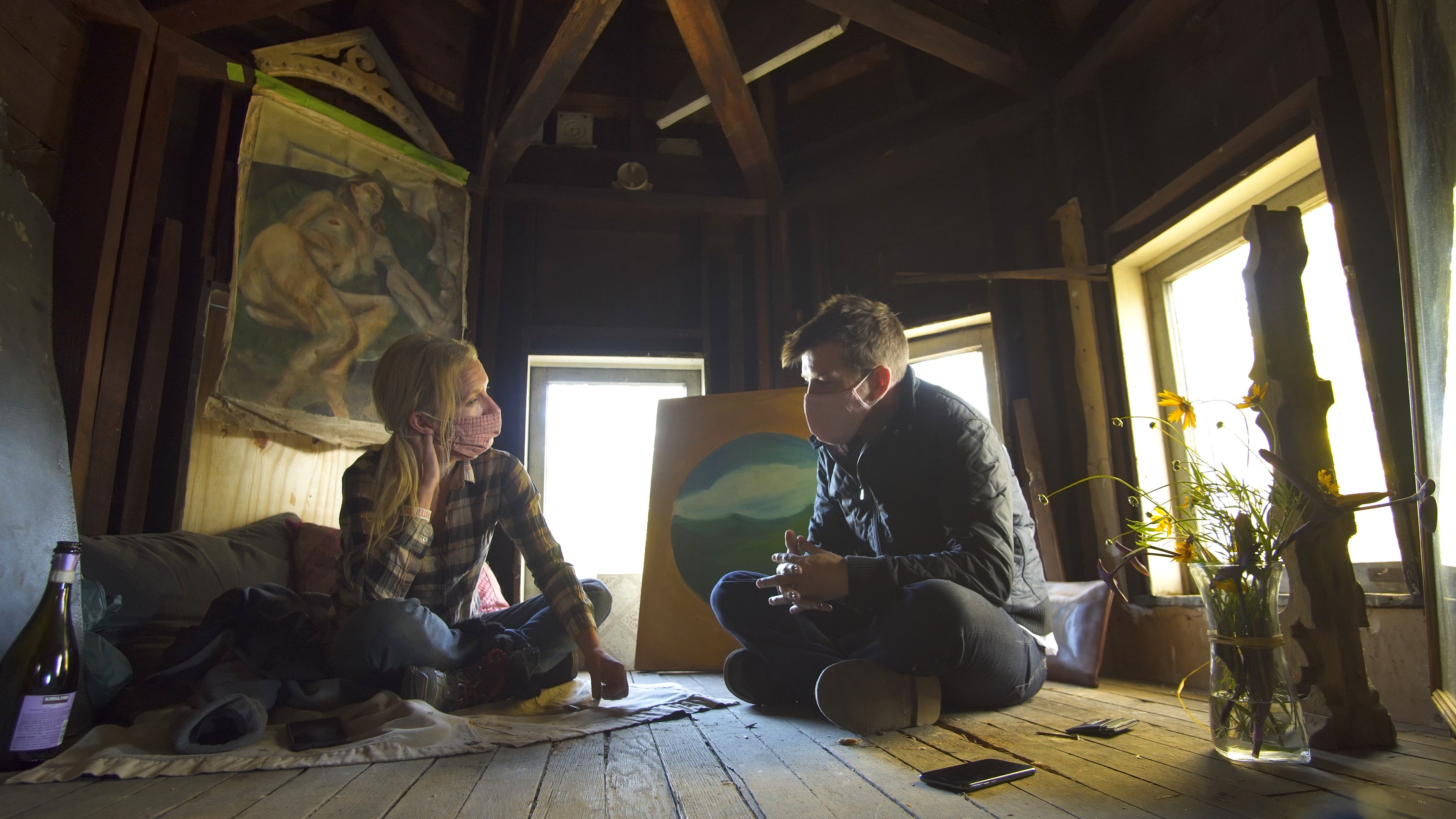 The new owners discuss their financing options in the third floor cuppola, which they've decorated with eclectic treasures found around the house