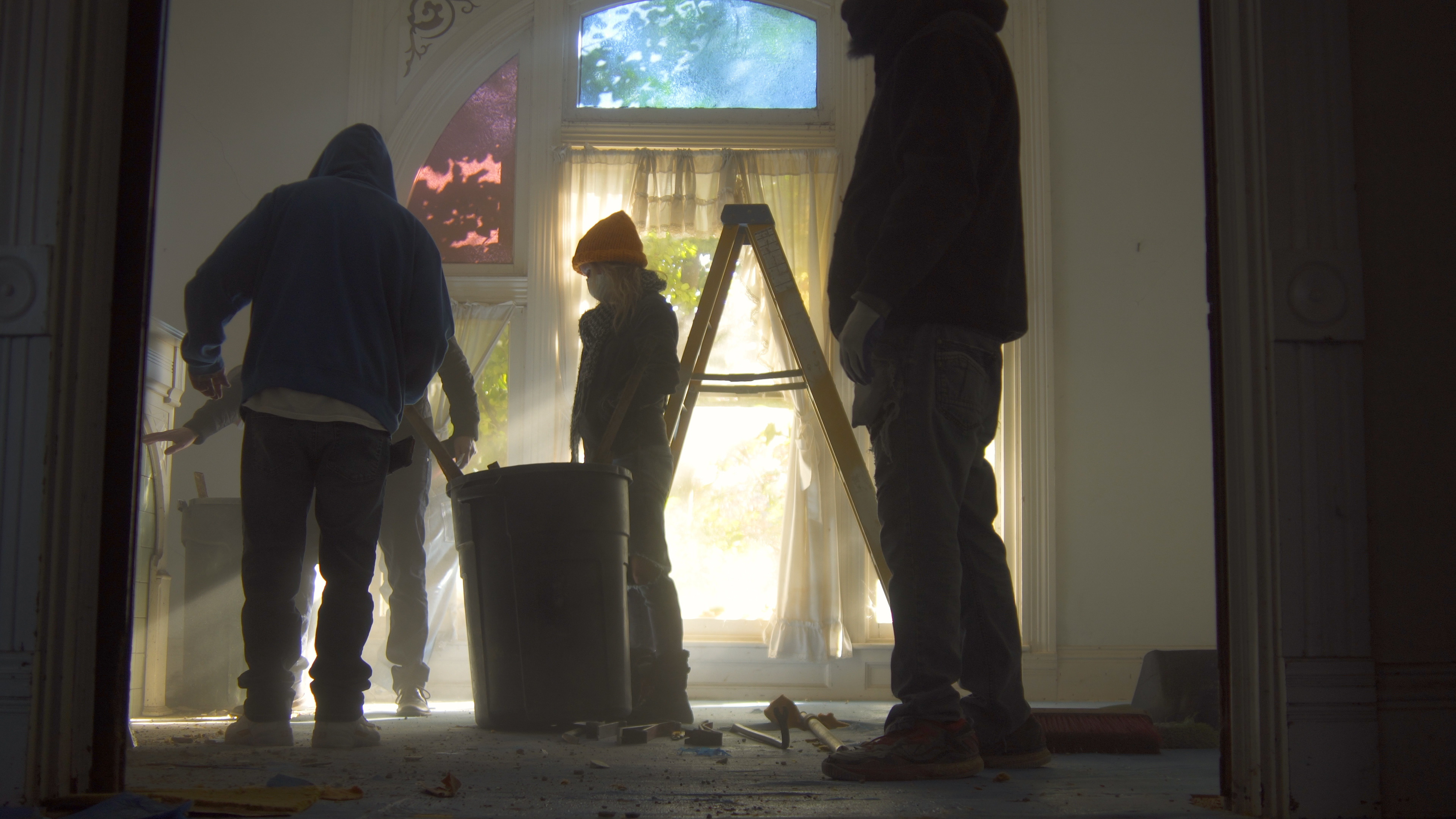 Morning light streams in, illuminating the dust arisen from the demolition