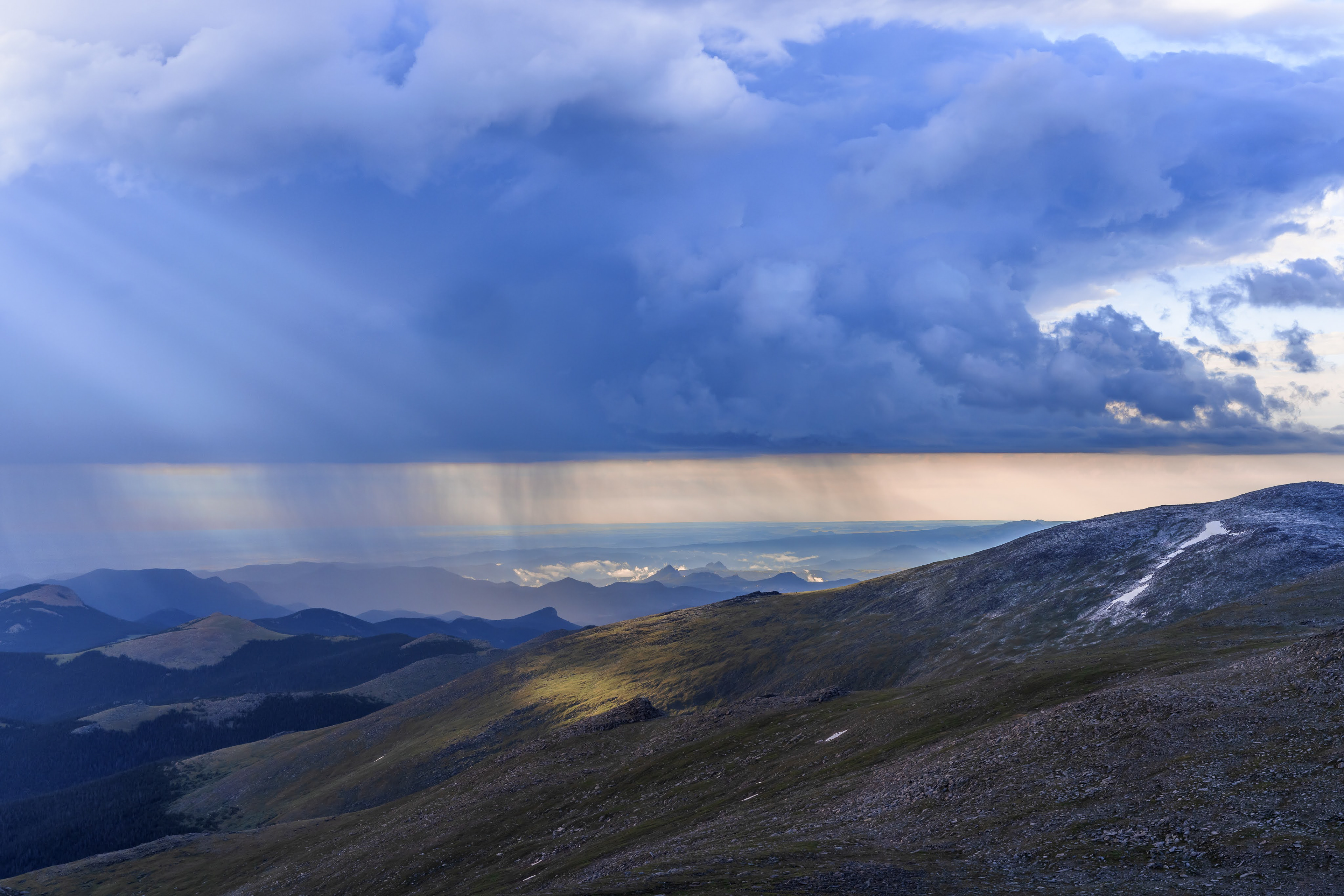 Summer weather on Mount Blue Sky is dynamic and beautiful.  A late afternoon rainstorm pours on the peaks near the Mount Blue Sky summit.  Colorado