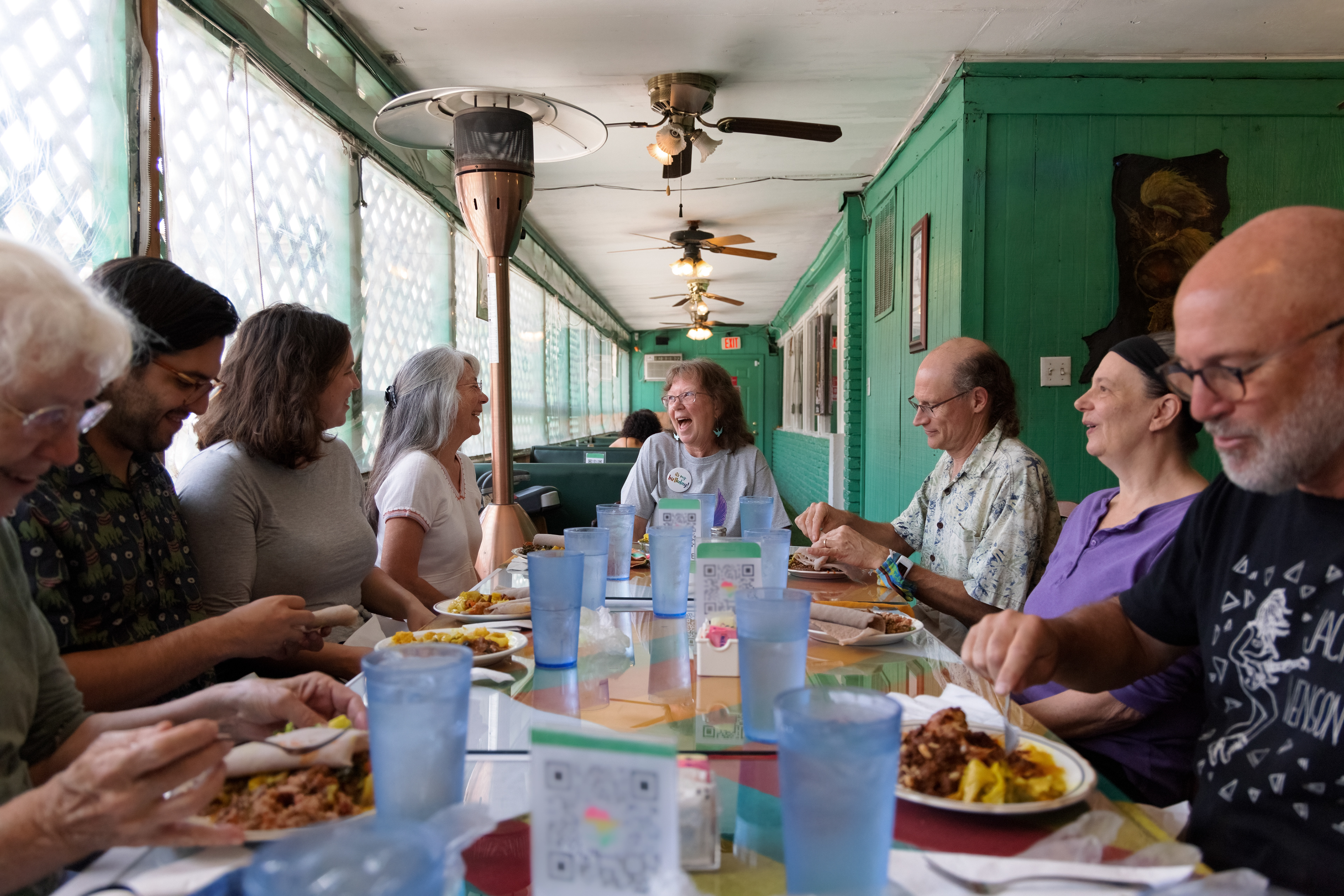 Julia Balinsky celebrates her birthday with her purple martin volunteer friends at Aster’s Ethiopian restaurant. These friendships were made by bonding over their love for purple martins. These little birds have a way of creating community. Austin, TX.
