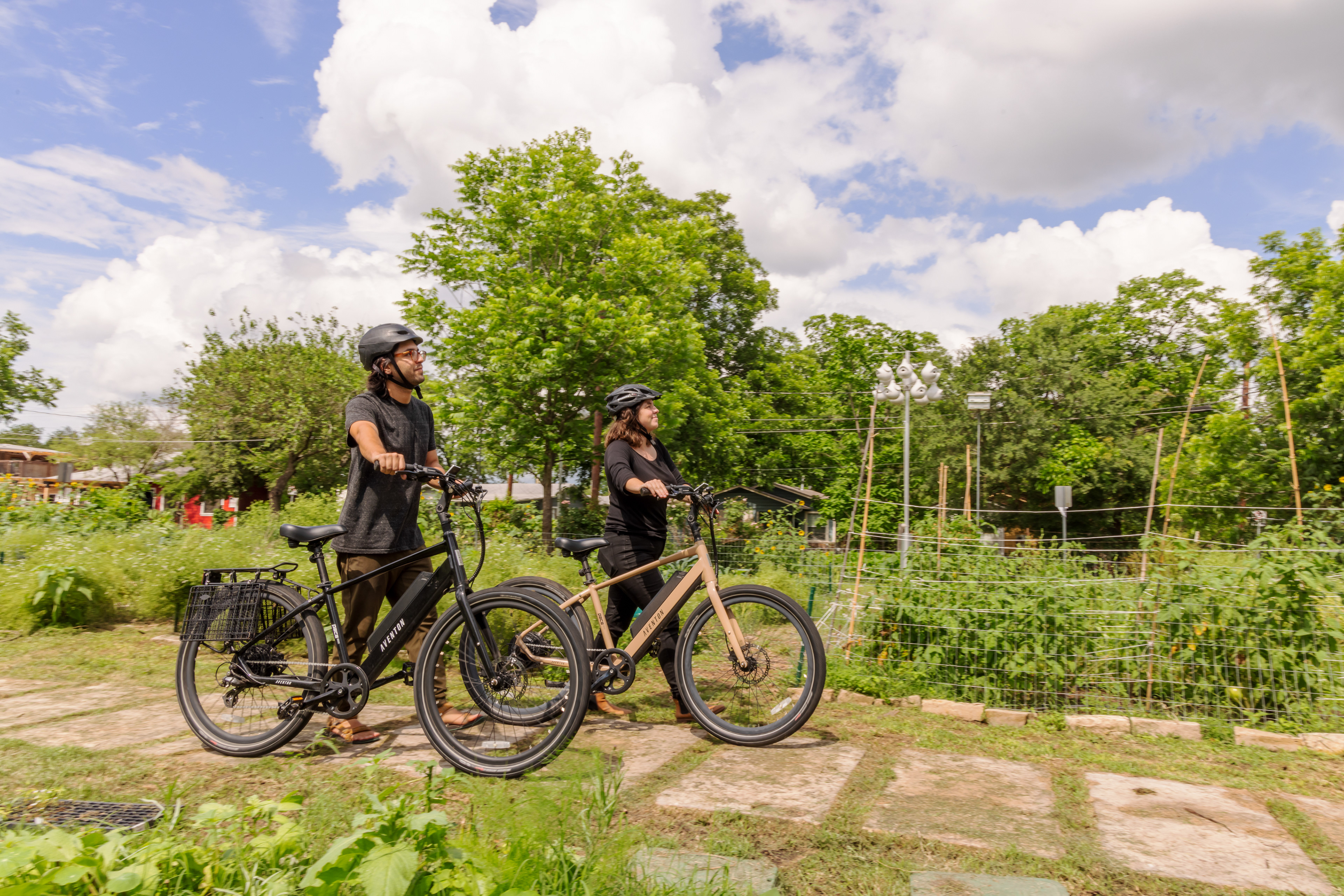 Purple martin landlords, Kevin & Alex bike from their house to the community gardens where their purple martin gourds are.