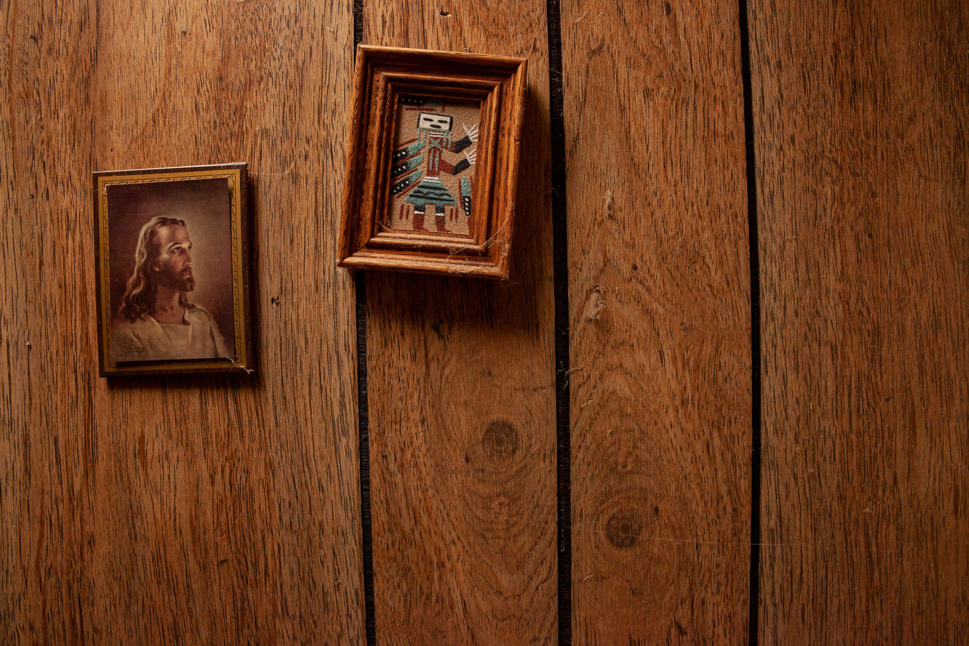 Inside Christopher Ewing’s mobile home the walls and decorum blend between Catholic religiosity, Pennsylvania Dutch folk art, a blend of antique furnishings and general plethora of spiritual cultural items. Here we see a picture of Jesus juxtaposed against an Indigenous American folk representation. 