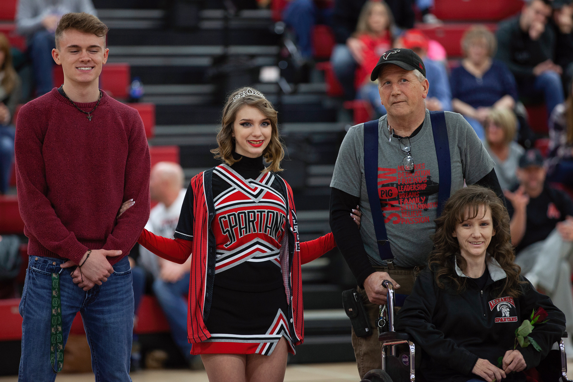 Trinity Sanders, 18, of Albany, Ohio, stands with her family before the last basketball game for Alexander High School, Feb. 15, 2019. Alexander High School honors each of their graduating seniors during their final games of the season by having them stand with their family before the whole stadium, and also by setting up a table to commemorate their time at the school.