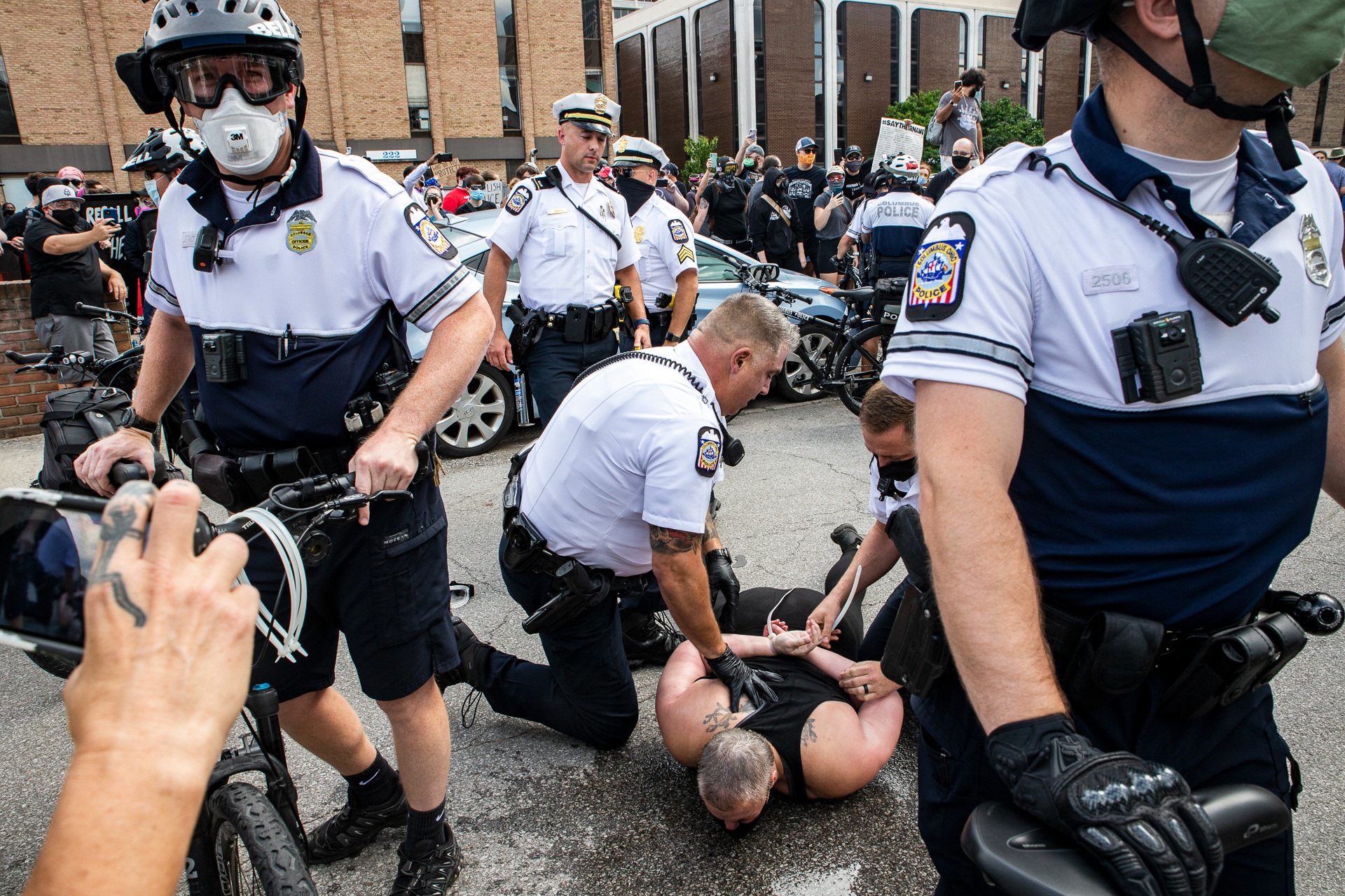 Columbus Police Officers arrest individuals protesting the Fraternal Order of Police (FOP) in Columbus, Ohio on July 31, 2020. Protesters blockaded the parking lot with cars, and were pepper sprayed and handcuffed when they would not move away from the vehicles. 