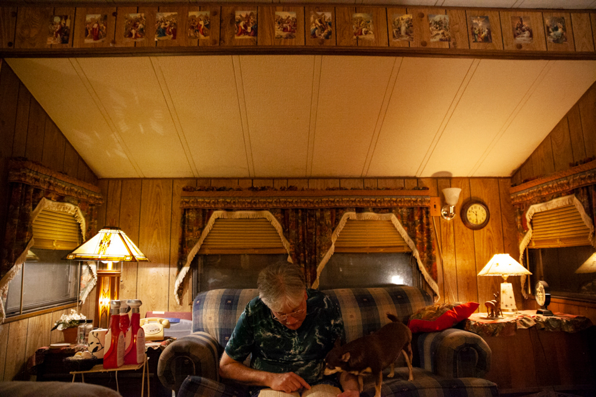 Christopher Ewing, leafs through an antique toy catalogue from 1965, with his trusted seven year old chihuahua, Chipper, inside his mobile home in Albany, Ohio. "It had every toy that every kid would want, so that catalogue is some 50 years old," remarks Ewing. Structure and consistency help Ewing reduce his stress caused by the changing world around him. When he was first admitted into a mental hospital he commented, "I didn’t think of it as me being locked in, I thought of it as the world being locked out."