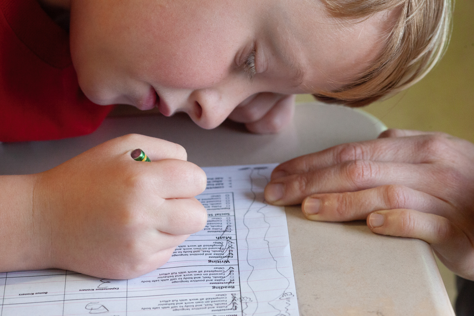 Rhys Whealey, 9, of Athens, Ohio works on counting up his merits from the end of the day with the help of his teacher in the Haugland Learning Center, Albany, Ohio, Mar 28, 2019. Students at Haugland can receive merits in exchange for good behavior, and can spend those merits on different kinds of free time and/or prizes.