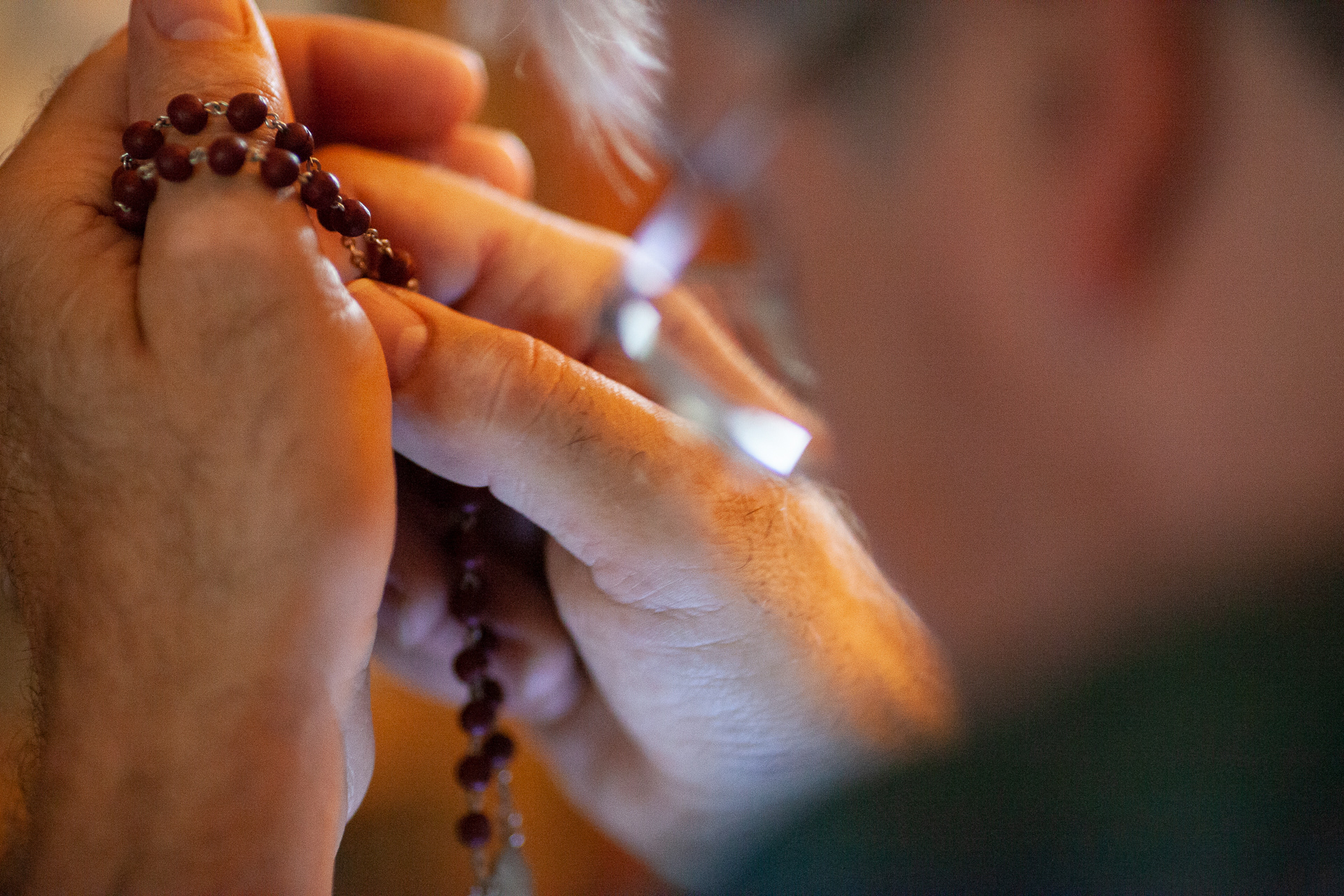 Christopher Ewing recites prayers with his rosary, as part of his private practice inside his mobile home in Albany, Ohio. When Ewing was an undergraduate at Ohio University, studying art, he took a trip to the Vatican, and was so overcome with the spectacle of the Catholic Church that he decided to join. Ewing recites prayers during the day and at night, and he says religious practices like these help him to manage his schizophrenia along with his medication. 