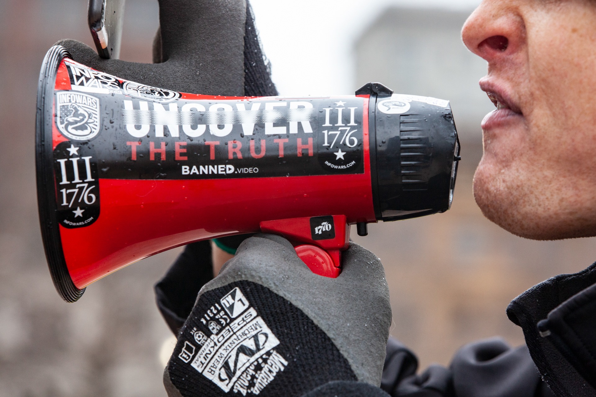 A protester touting conspiracy theories yells over a bullhorn in front of the Ohio Statehouse in Columbus, Ohio, January 17, 2021 during a nationwide protest called by anti-government and far-right groups supporting US President Donald Trump and his claim of electoral fraud in the November 3 presidential election. - The FBI warned authorities in all 50 states to prepare for armed protests at state capitals in the days leading up to the January 20 presidential inauguration of President-elect Joe Biden.