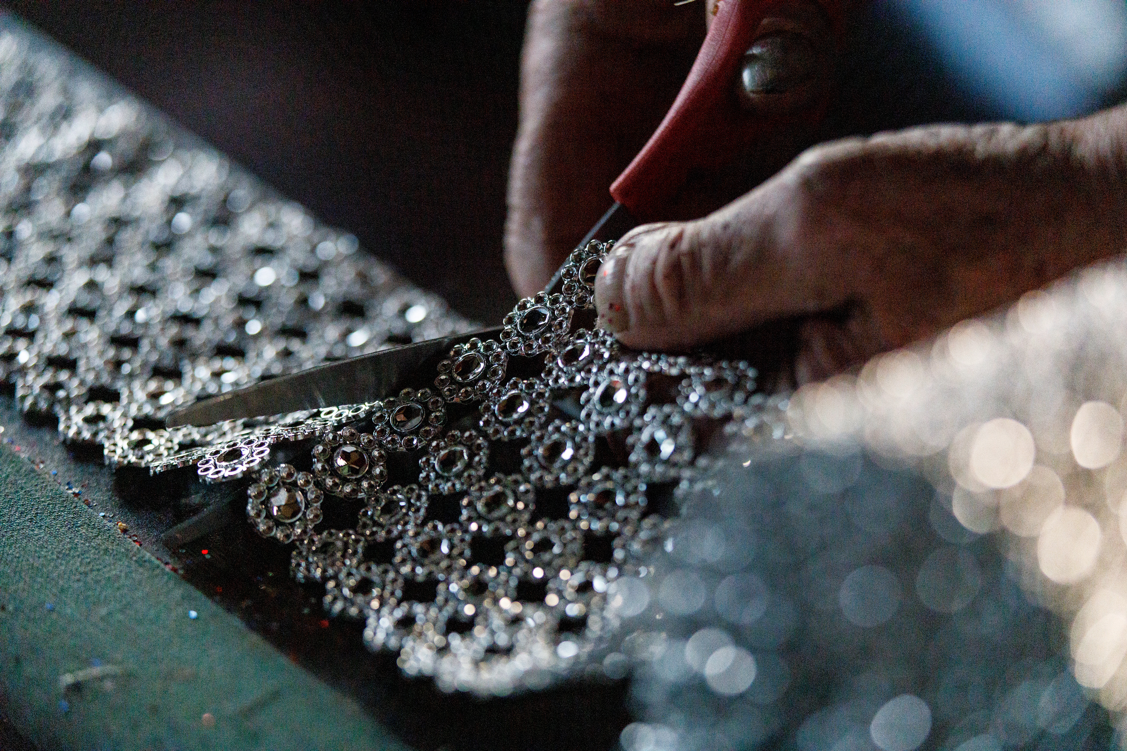 Bill Moore, 87 of Stoney Ridge, cuts glittery fabric to add to decorations he is working on in Stony Ridge, Ohio on Ocotober 13, 2021.