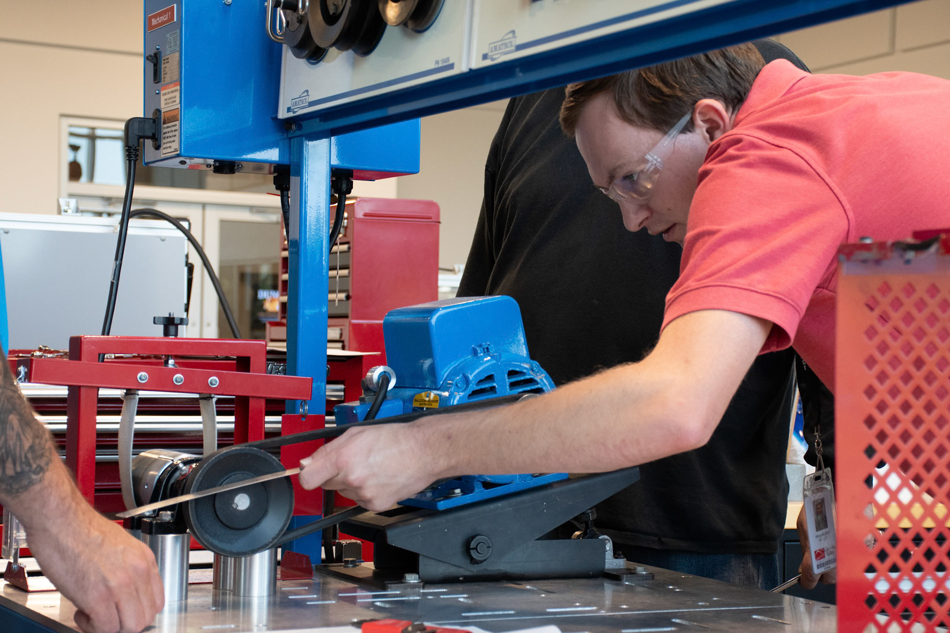 Instructor Ryan Wilson checks the work of students in mechanisms lab 10/8/2024