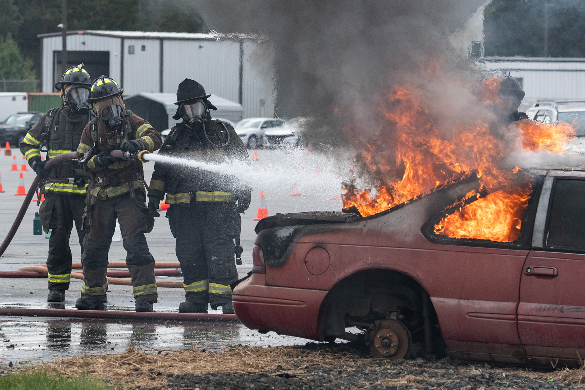 CVCC Fire academy students, along with Instructor Rhodarmer, extinguish burning car during car burn exercise 10/15/24 Conover, NC