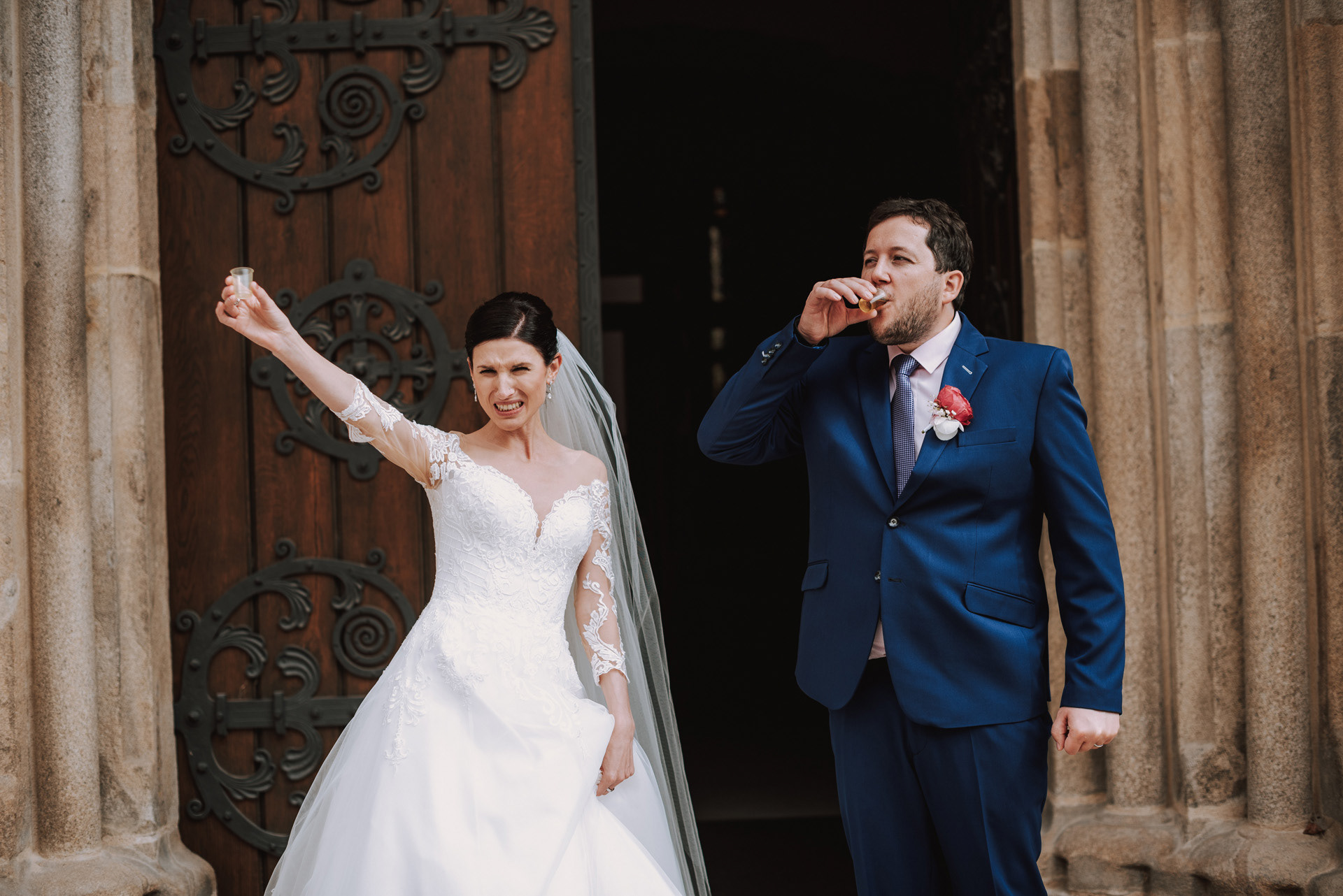 novomanželé si dávají panáka před kostelem