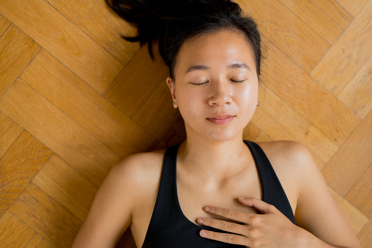 Jem, a yoga teacher in Rotterdam who offers one-day and weekend retreats, with her eyes closed and one hand on her heart.