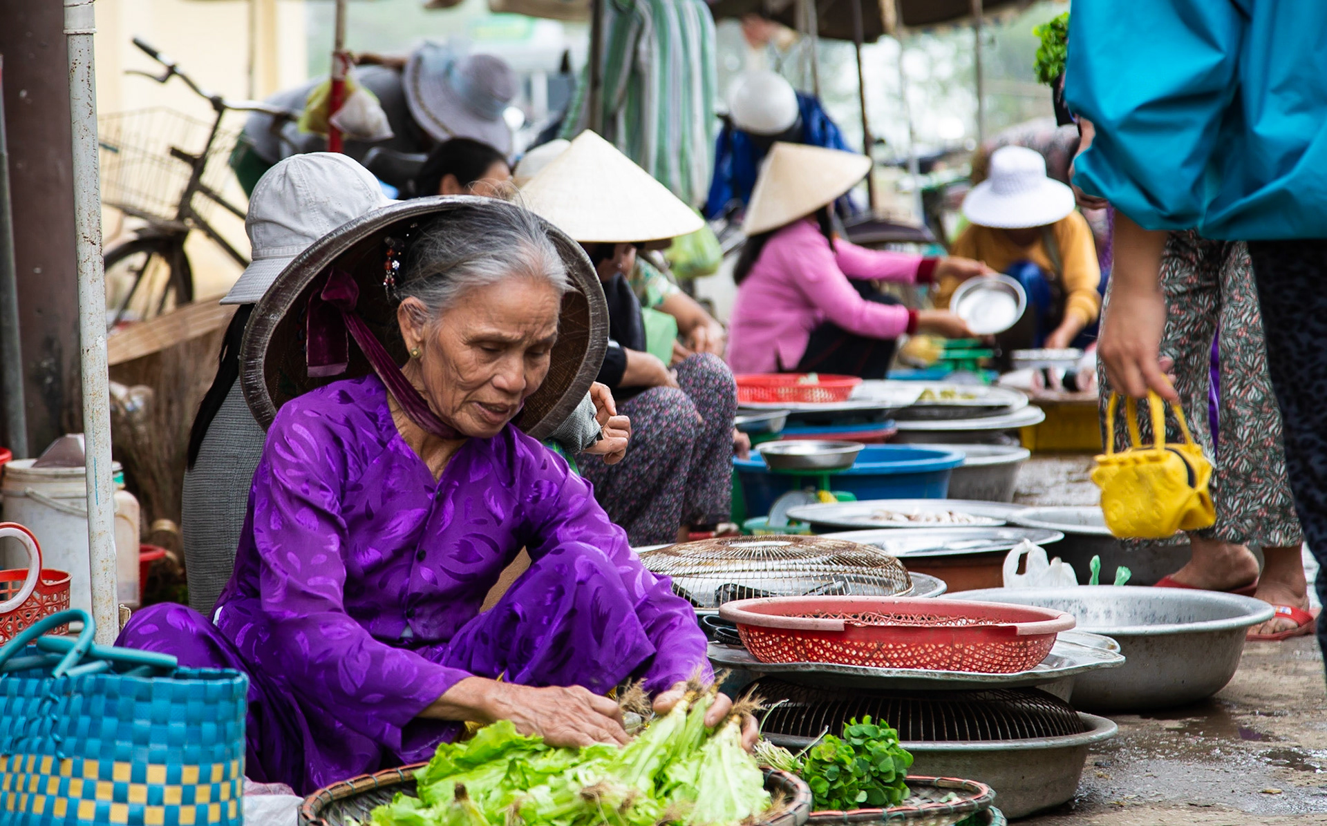 A Lady in a market of a little town selling salad.