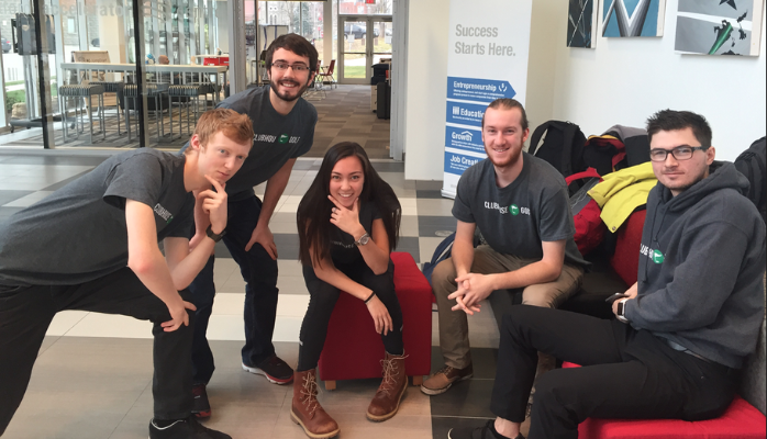 Group of university students posing casually for team photo