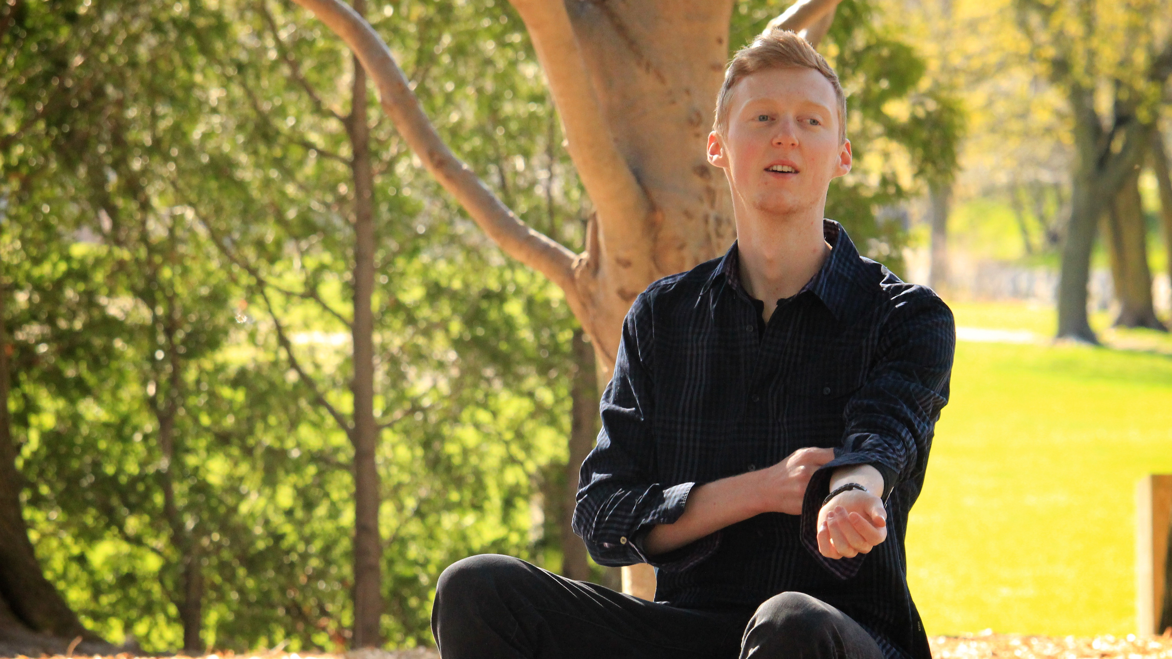 Photo of Calen Siddall sitting in a park
