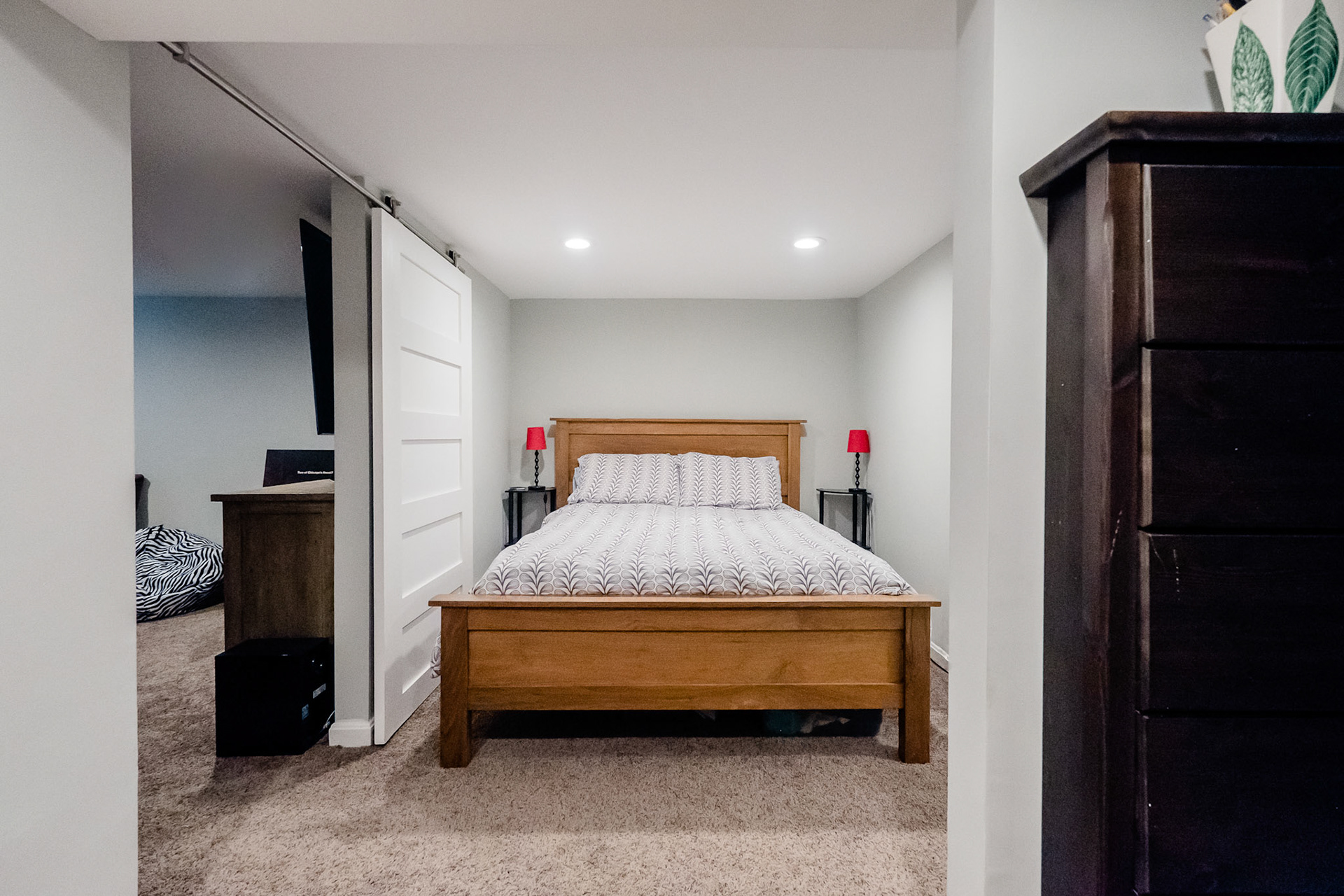 The basement was renovated to include a guest bedroom with barn doors.