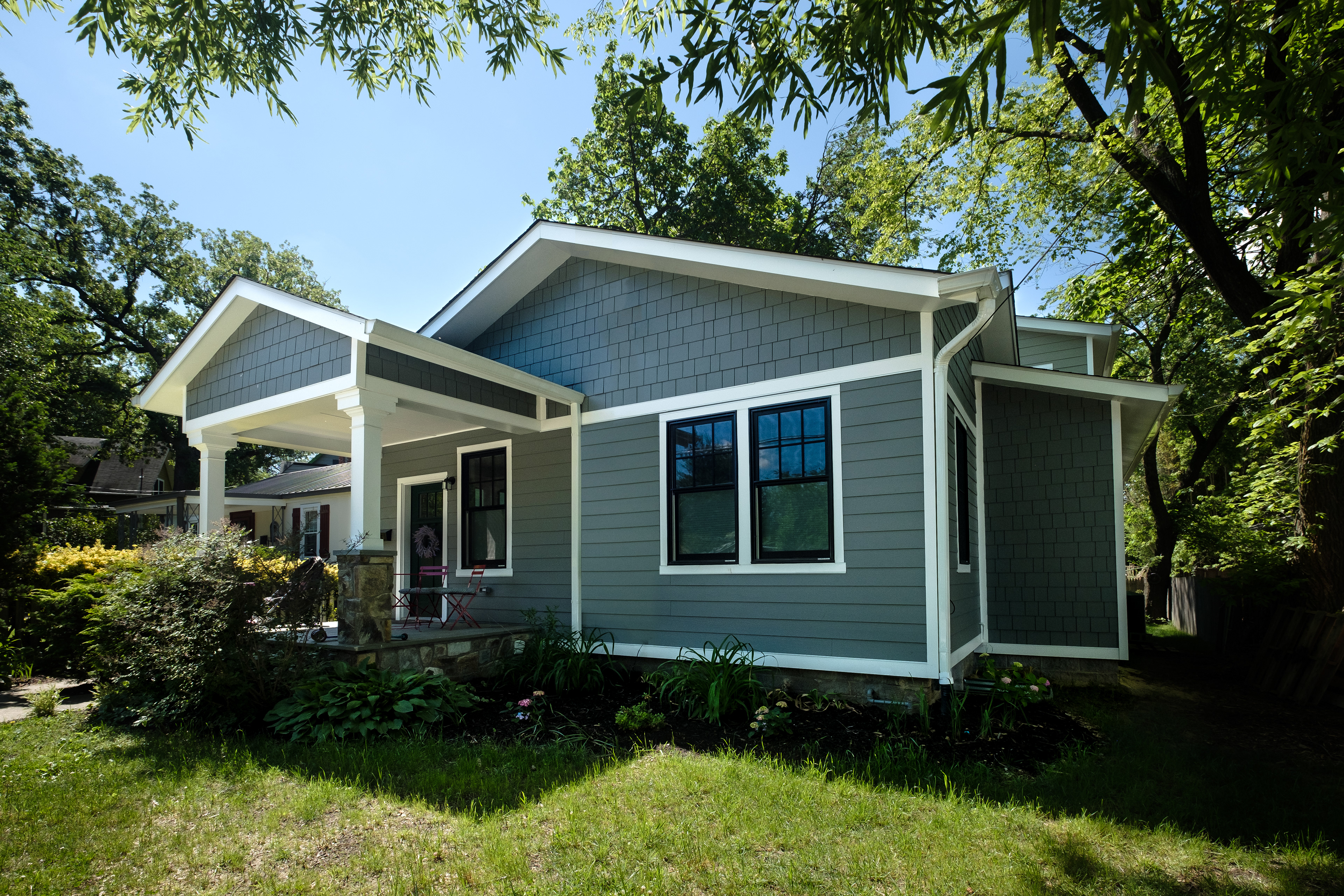 The historic detailing, removed in past remodels, is restored on the front elevation.