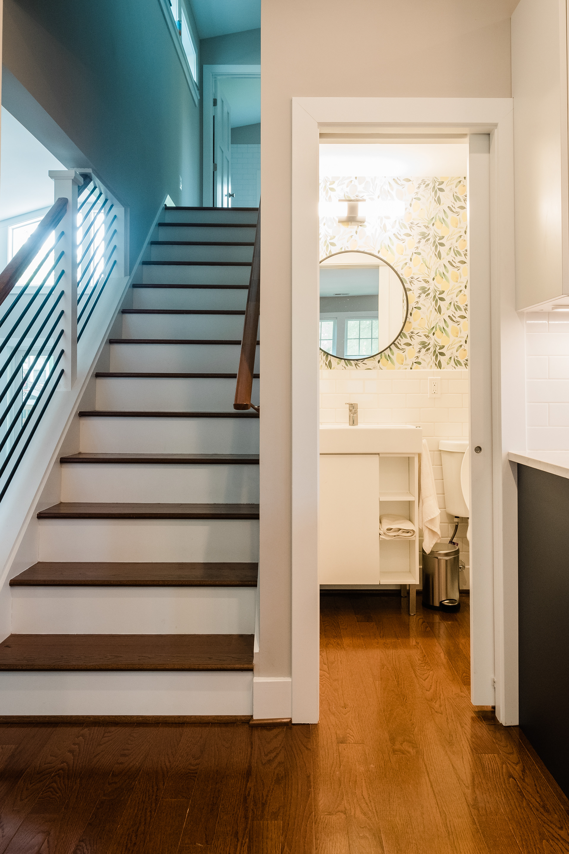 Half bath is tucked in next to the stairs.