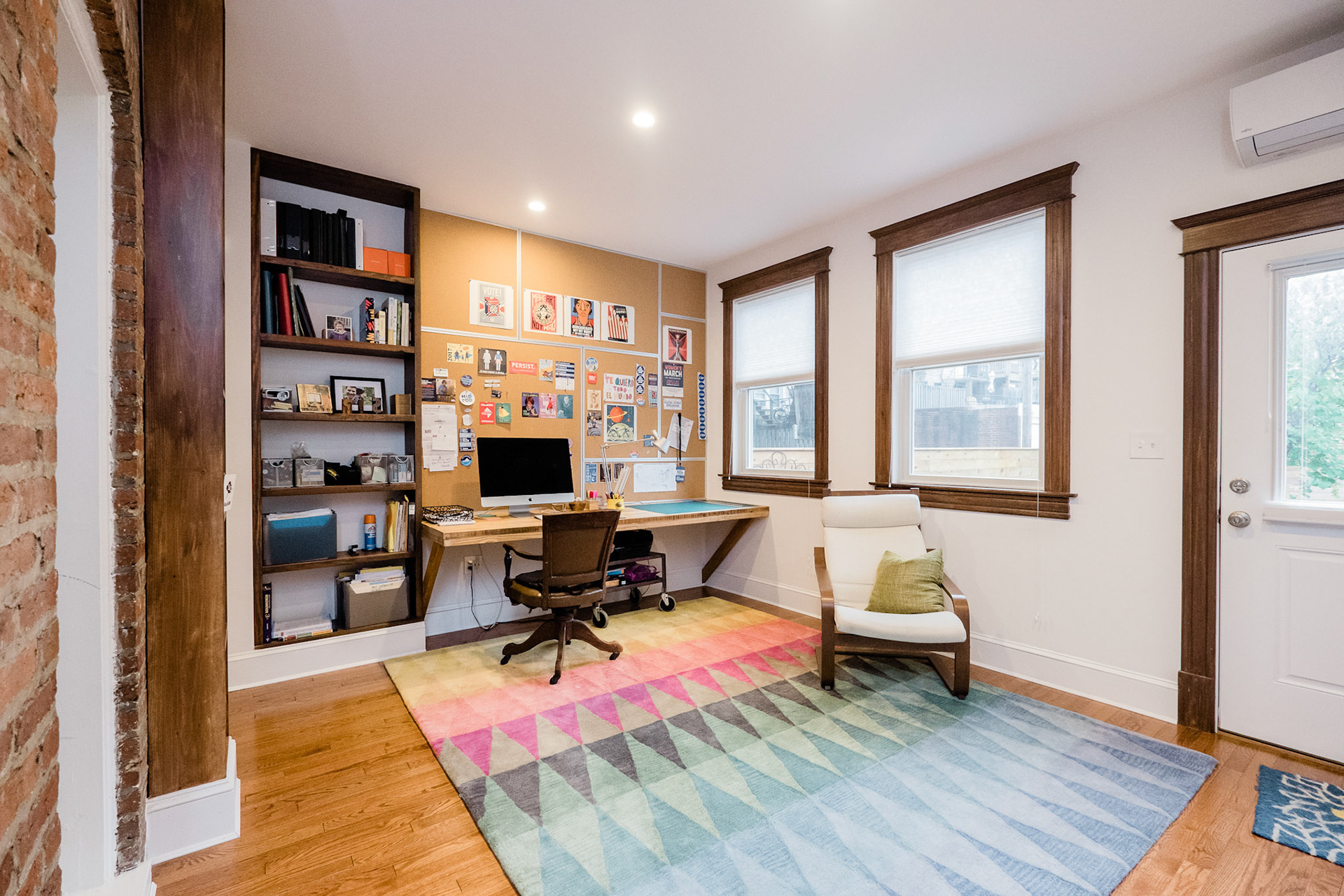 The first floor has a spacious home office with room for seating and access to the rear yard.