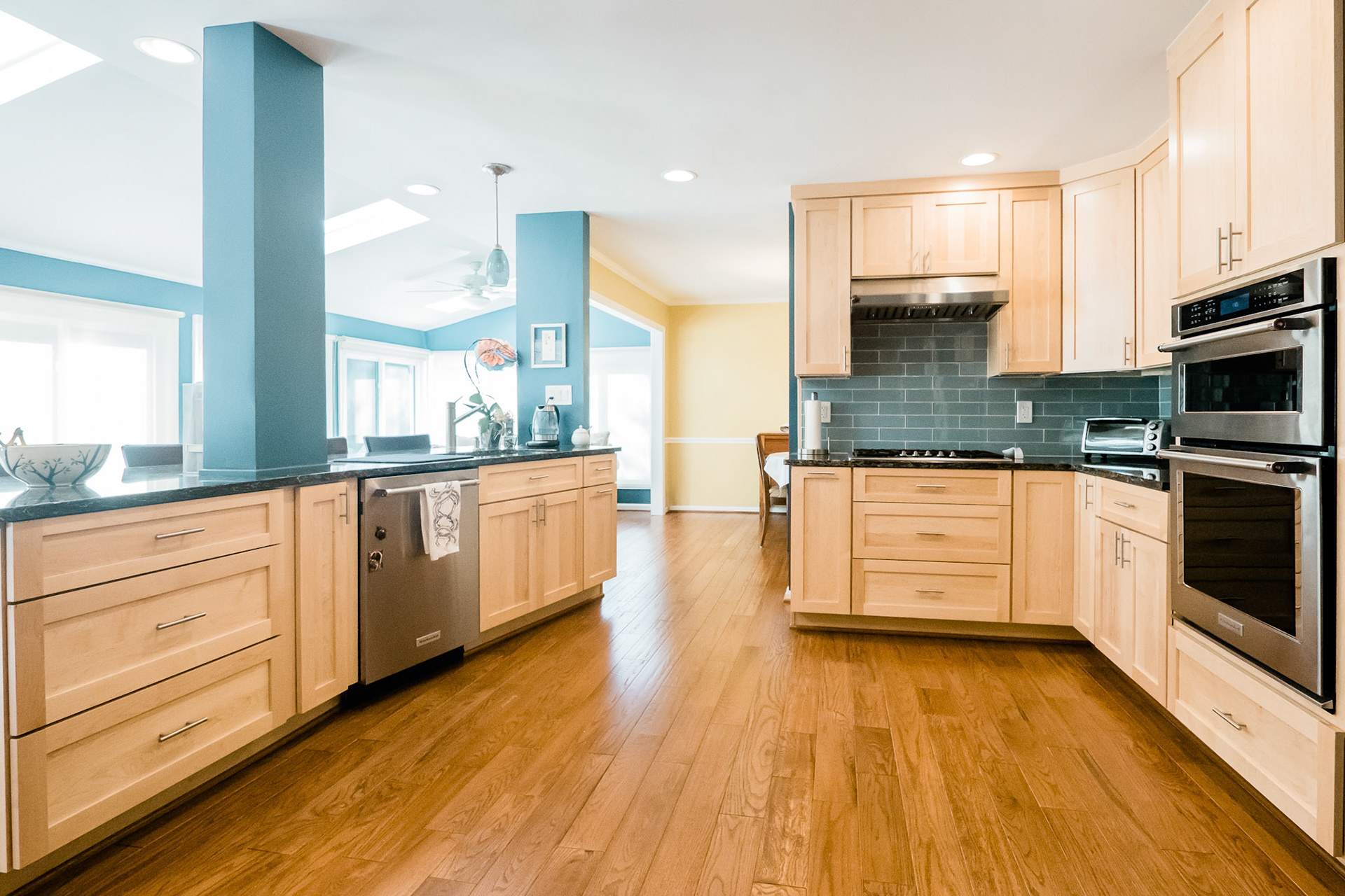 The renovated kitchen opened up to the existing dining room beyond.