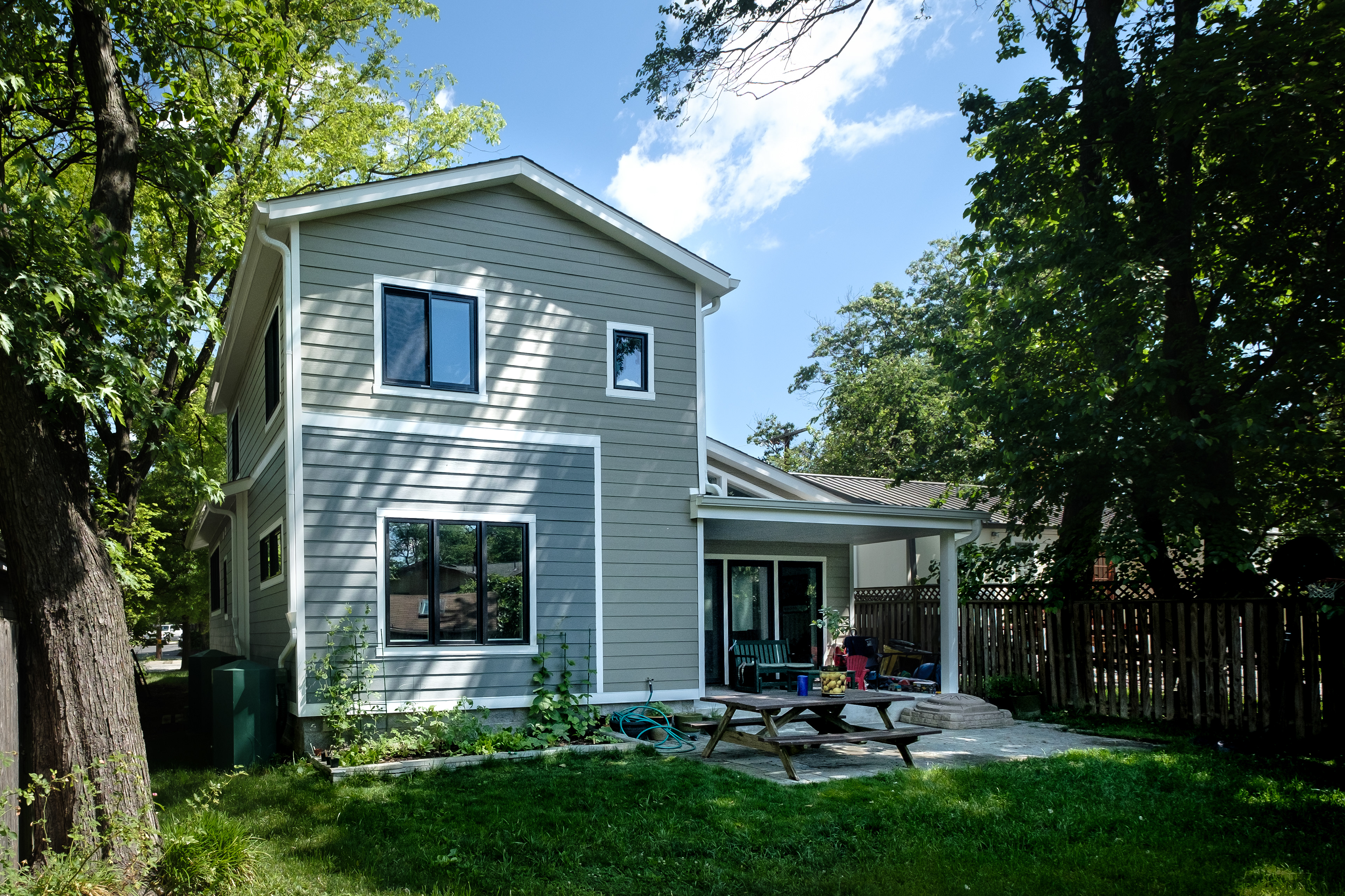 The backyard elevation maintains a more modern aesthetic.