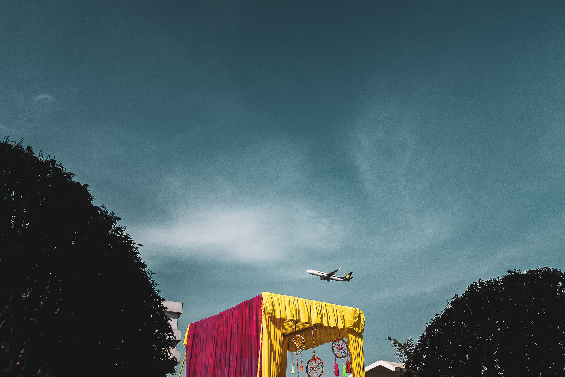 A destination wedding mantab with an plane flying above.