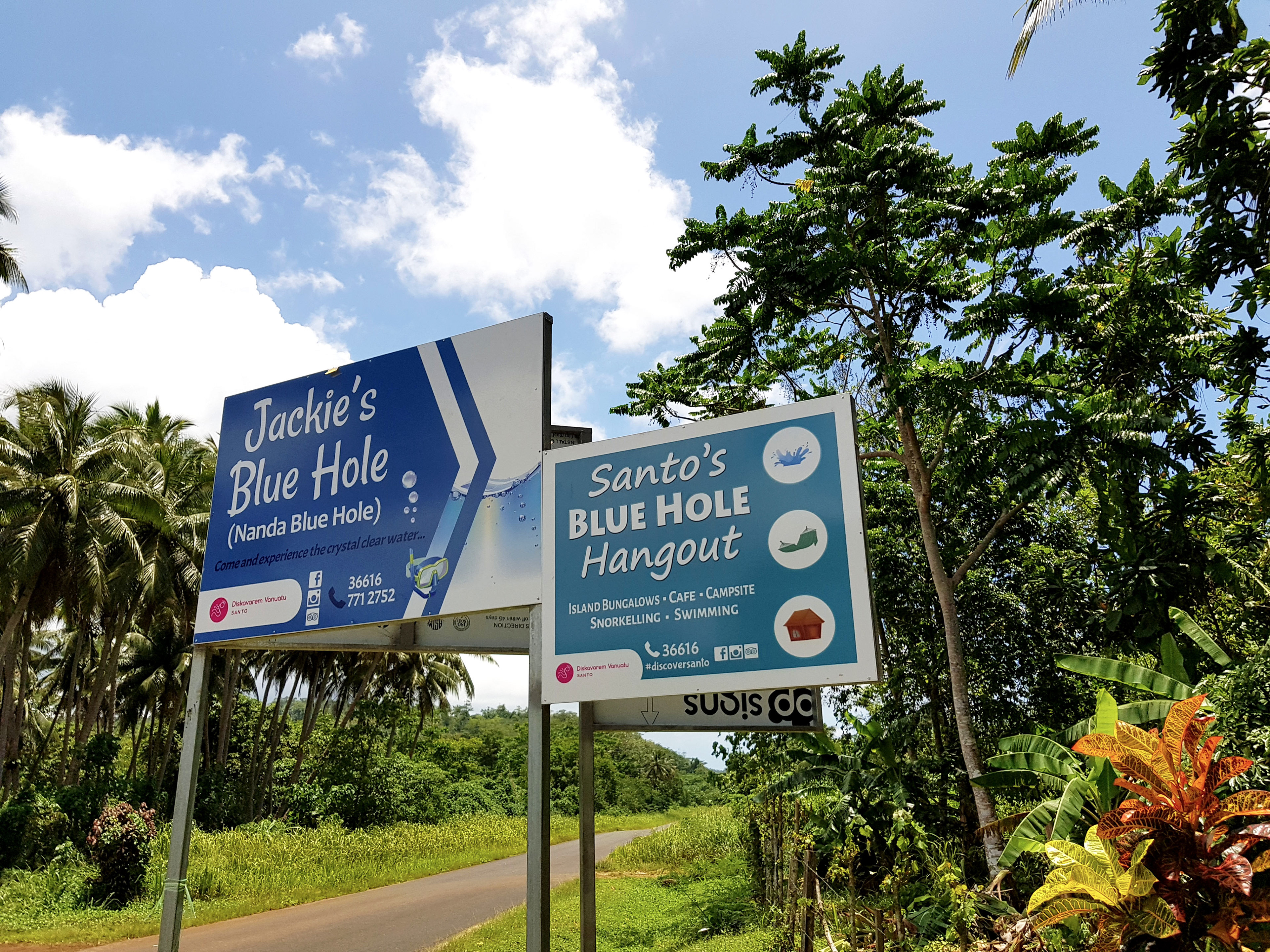 Jackie's Blue Hole, and Santo's Blue Hole Hangout Road Signs on the East Coast Road, Santo