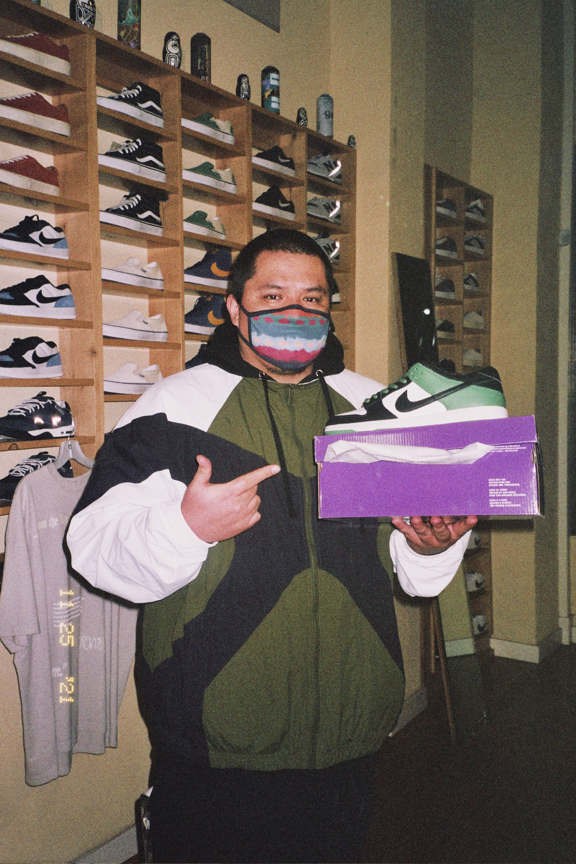 A customer poses with the pair of Nike SB Dunk Low Classic Greens he won via raffle.