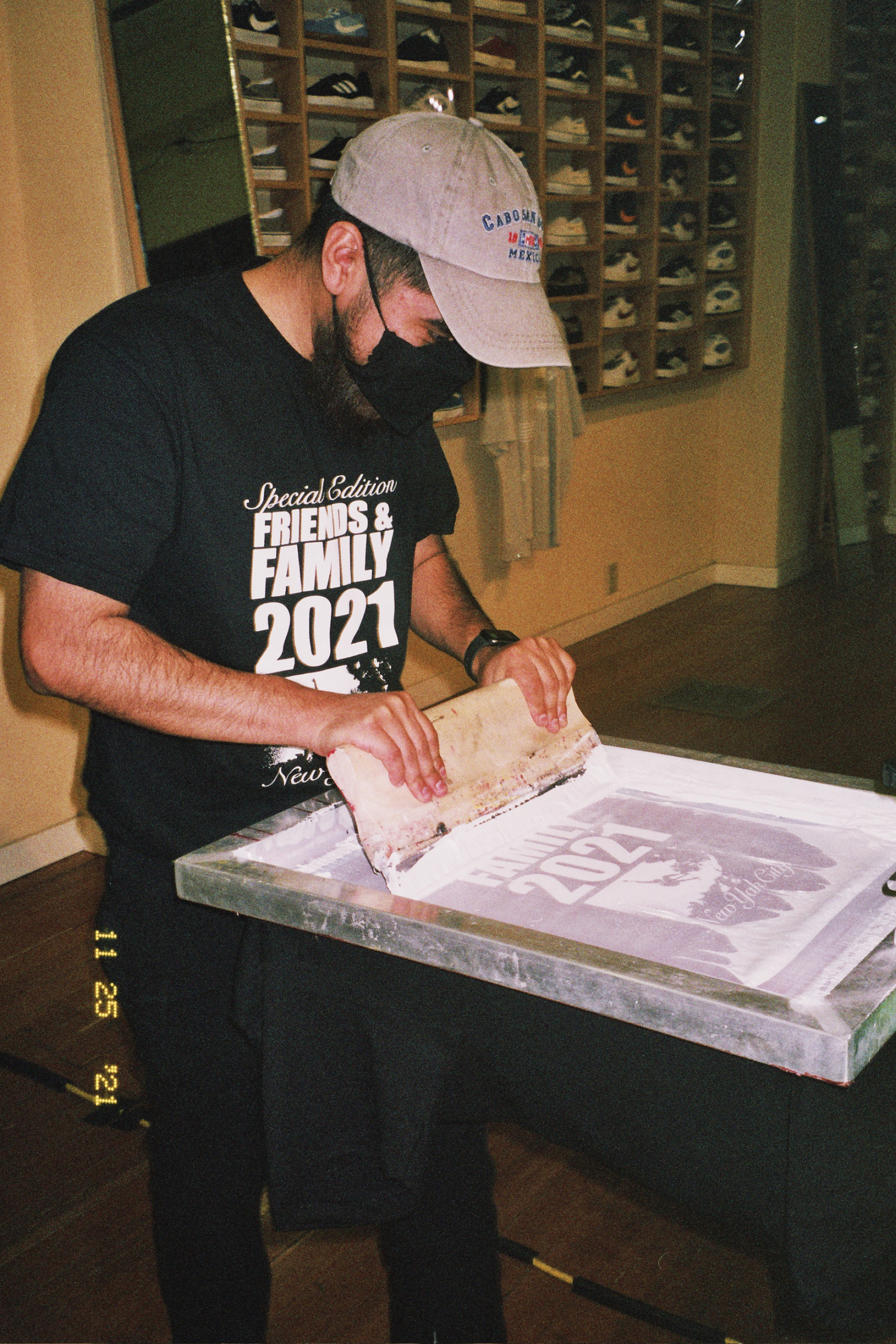 Ozzie screenprinting Nike SB Dunk Low Classic Green at the New Yak City Black Friday event.