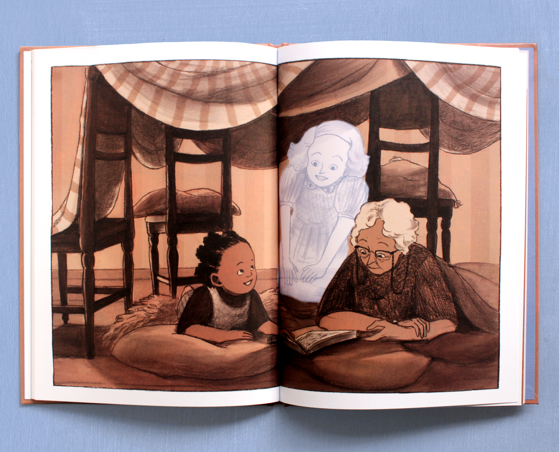 Inside pages: Leah, Ana and Lucy read together.