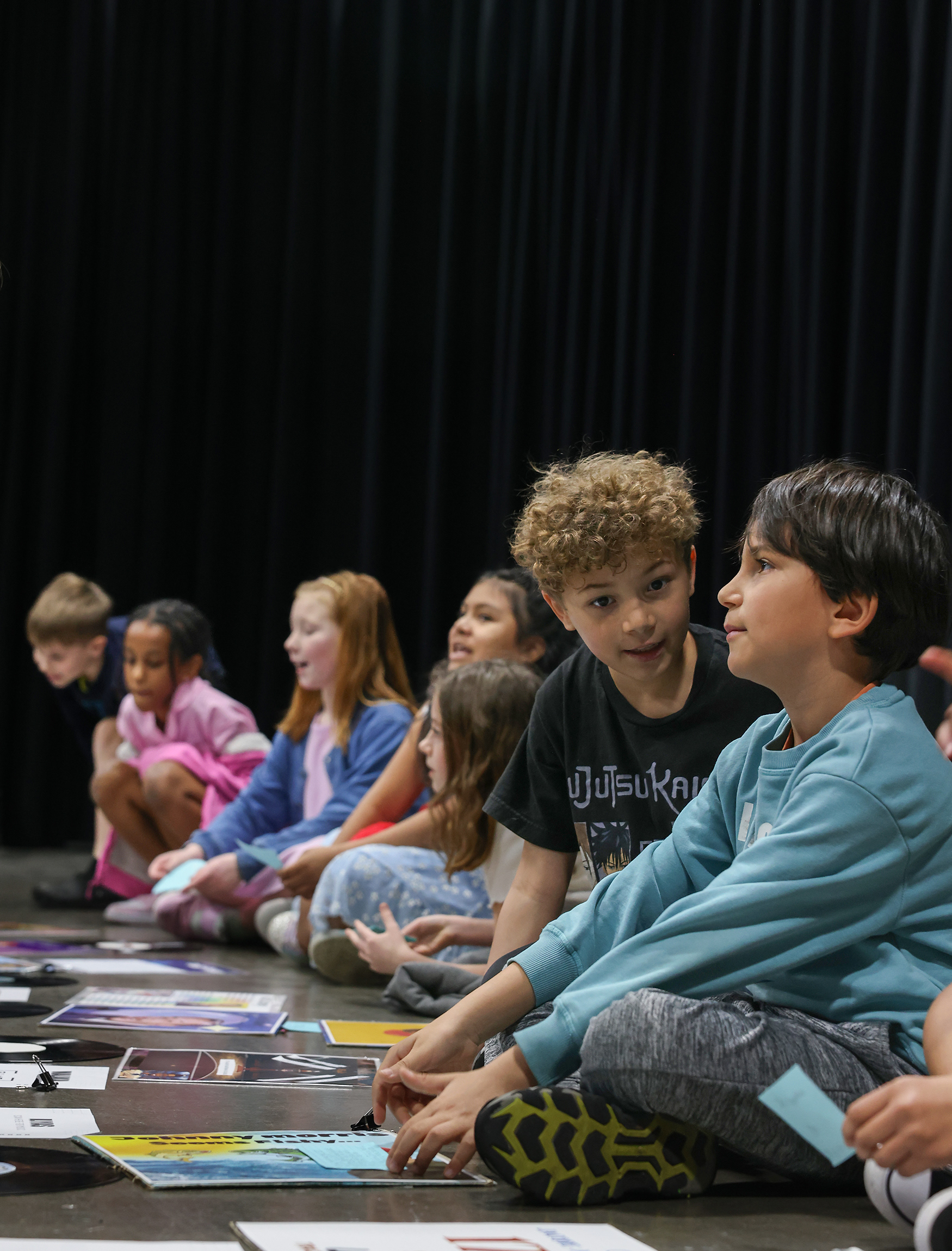 Ilyas Garayev, 8, and Malakai Hazlett, 8, show their art to their parents at the school’s art gallery on March 20 at Locust Street Expressive Arts Elementary in Columbia. The showcase was followed with a lunch.