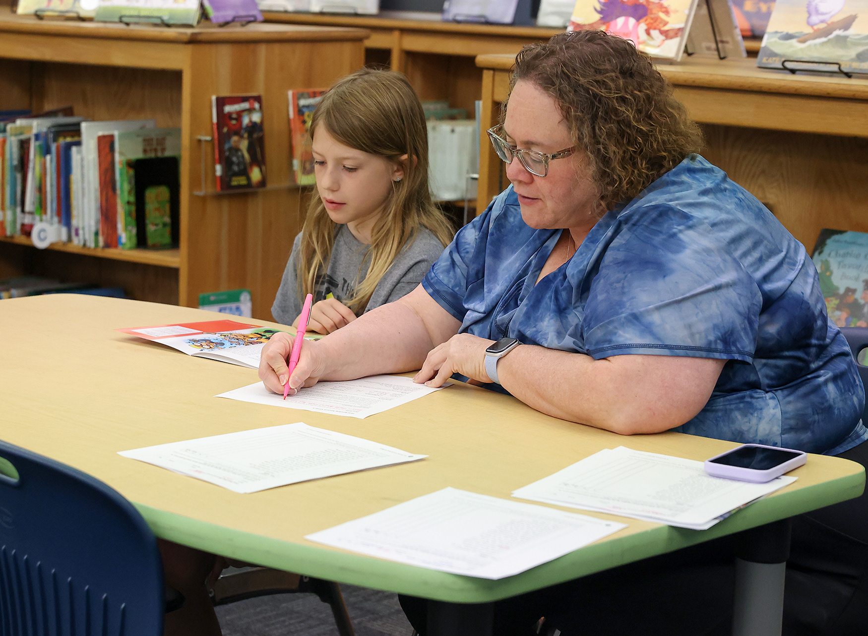 Instructional mentor Laura Sandstedt works with Wren Ritzo, 10, in a one-on-one meeting on April 16 at Ridgeway Elementary School. Principal Taryn Brinlee said teachers work closer with individual students and provide more small group instruction due to how they structure their intervention and small group reading blocks.
