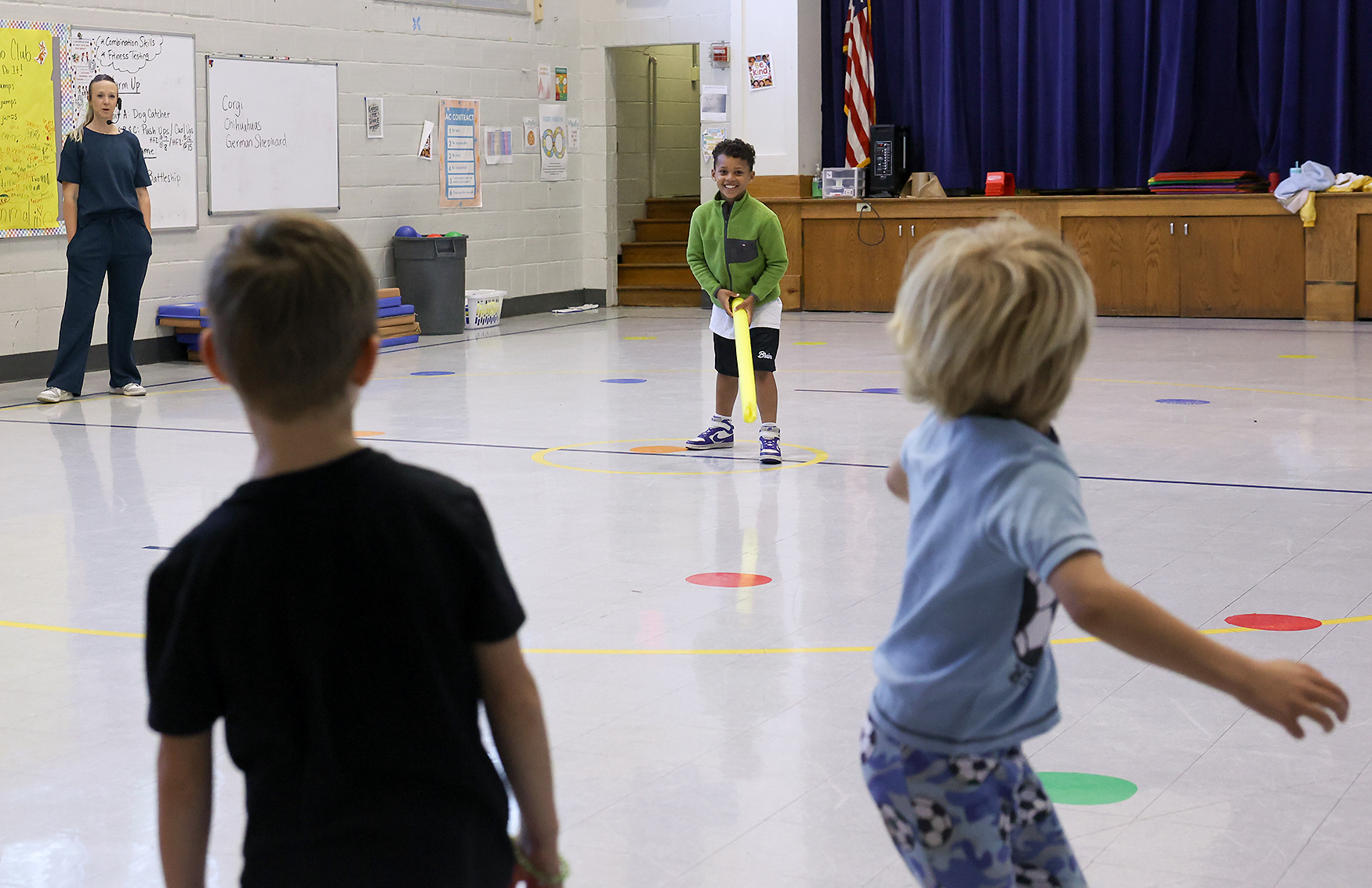 Physical education teacher Elizabeth Simmons, left, supervises a game with Lachlen Alvis, 7, and classmates on April 16 at Ridgeway Elementary School. Principal Taryn Brinlee said having students of varying ages in the same class helps older students develop leadership skills through interaction with the younger students.