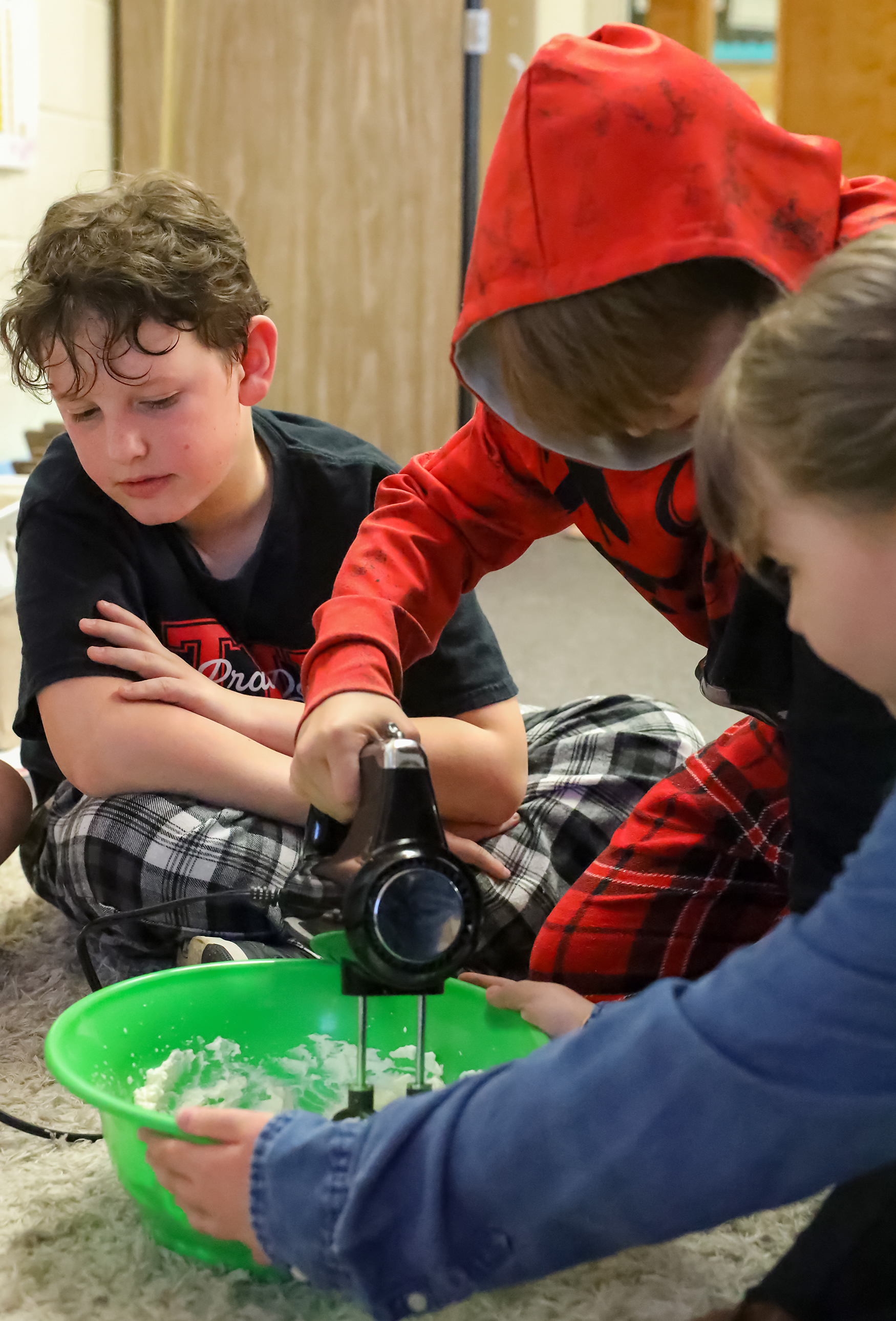 Ethan Childers, 10, watches as his classmate whips homemade whipped cream on March 19 at Two Mile Prairie Elementary School. The whipped cream is made out of heavy whipping cream, sugar and butter. 