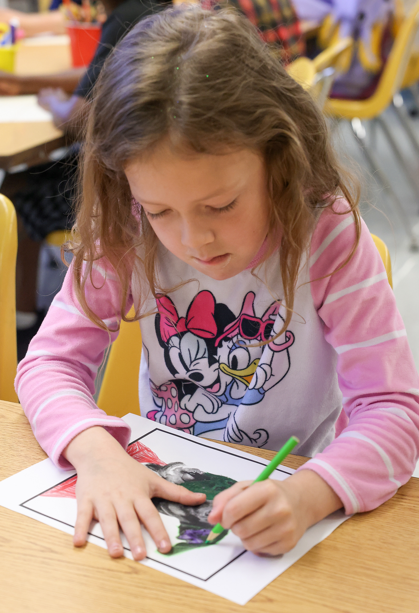 Caroline Karnes, 6, draws during art class on April 16 at Ridgeway Elementary School. Ridgeway Elementary has a multi-age learning program, where students meet in small groups to do more focused learning every morning.