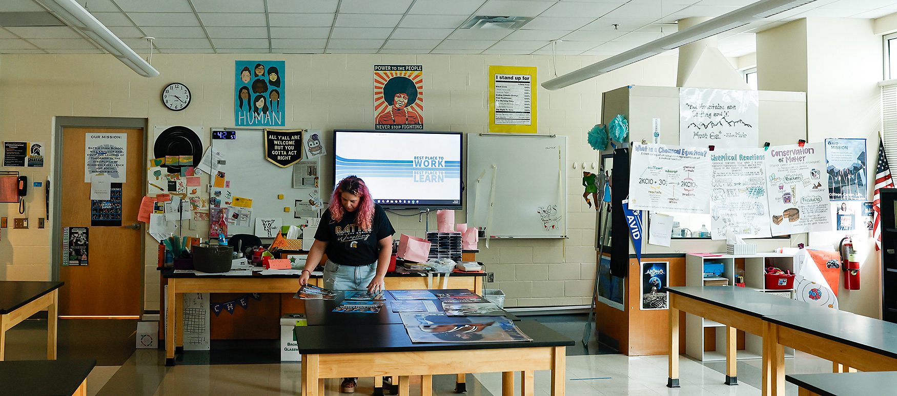 Kelsey Mescher looks through archived roller derby posters in her science classroom on April 18 at Battle High School in Columbia. “I’ve been very intentional with my posters,” Mescher said. “I want my students to realize that they belong here, but also that people that look like them can do science and can succeed in science.”
